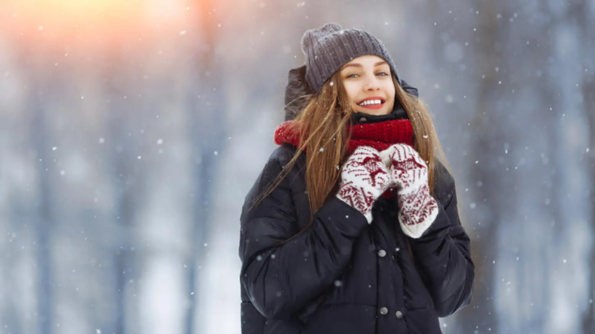 Winter young woman portrait. Beauty Joyful Model Girl laughing and having fun in winter park. Beautiful young woman laughing outdoors. Enjoying nature, wintertime.