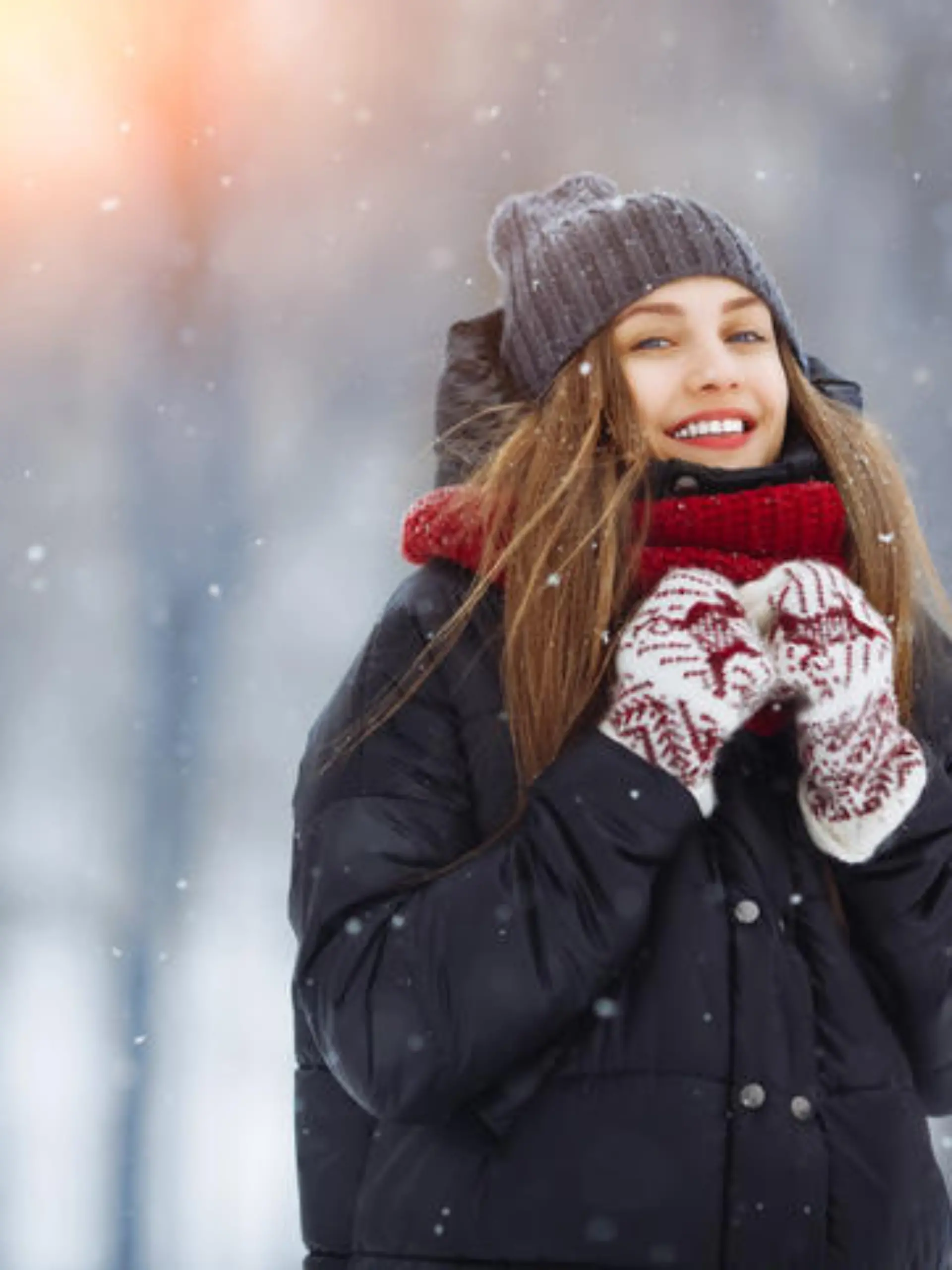 Winter young woman portrait. Beauty Joyful Model Girl laughing and having fun in winter park. Beautiful young woman laughing outdoors. Enjoying nature, wintertime.