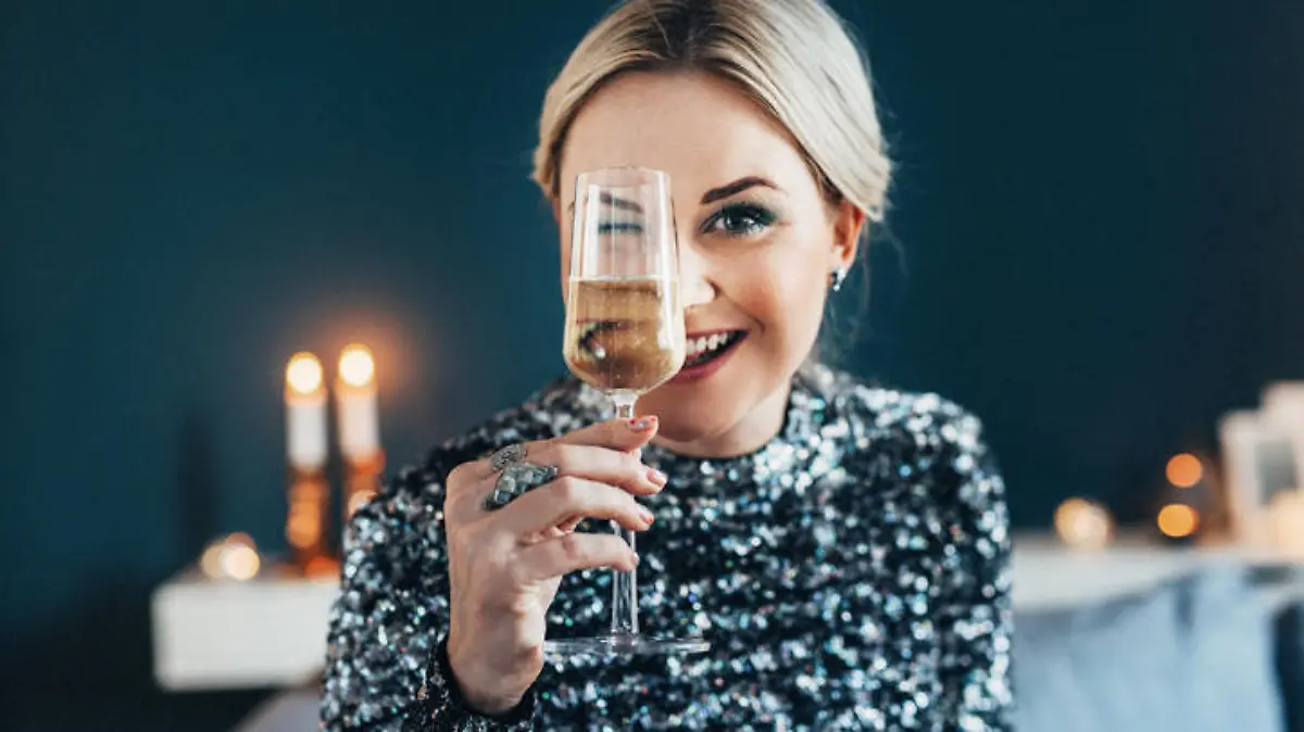 Beautiful woman celebrating new year with champagne