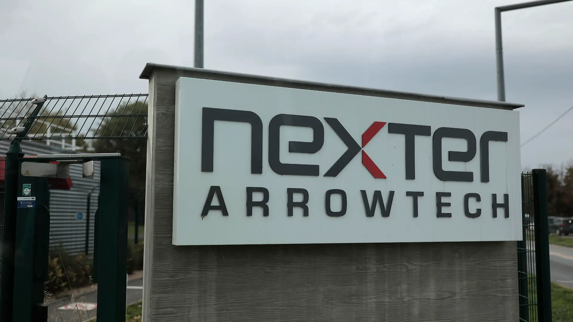 The entrance of the Nexter Arrowtech facility is pictured Thursday, Oct. 27, 2022 in Bourges, south of Paris. In a show of France's military prowess, President Emmanuel Macron has visited the Caesar cannon firing range and missile testing facility. The visit comes four months after Macron set out the need to adapt the French military to new conditions amid war in Europe. (AP Photo/Lewis Joly, Pool)