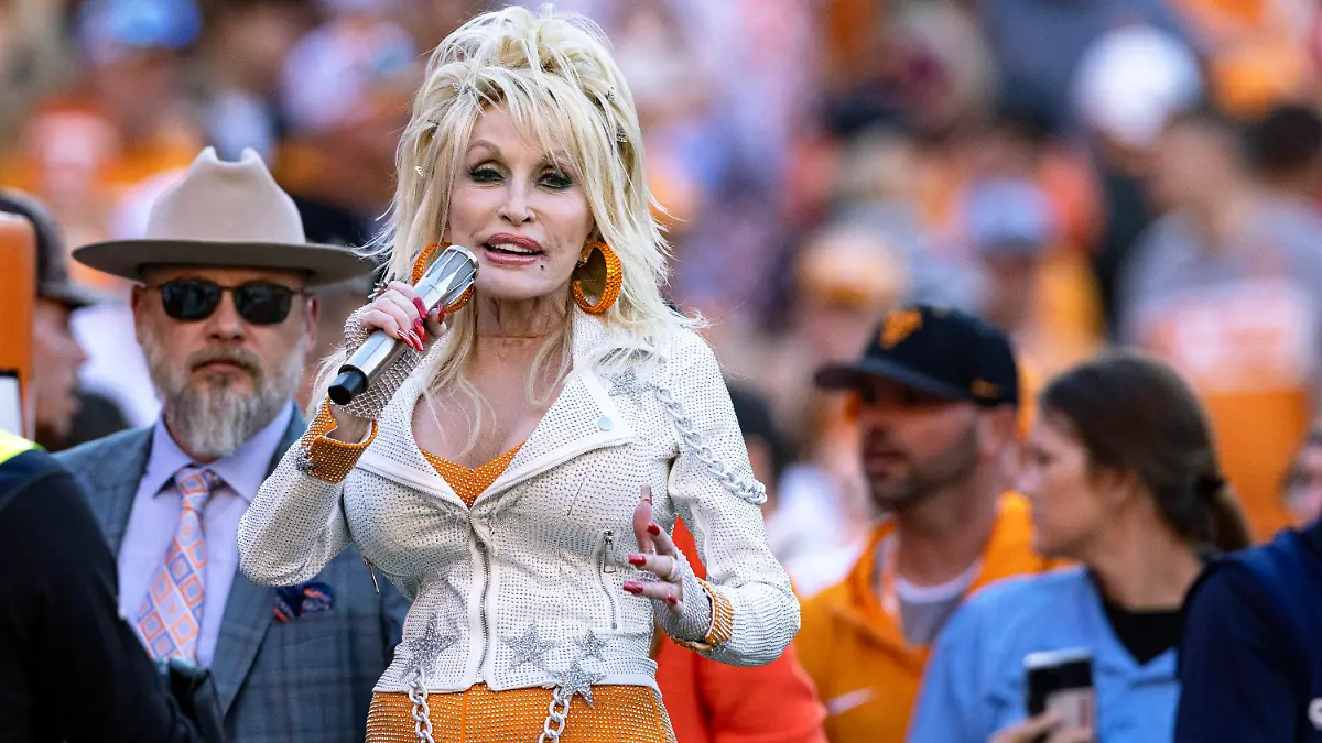 Dolly Parton performs during the first half of an NCAA college football game between Tennessee and Georgia, Saturday, Nov. 18, 2023, in Knoxville, Tenn. (AP Photo/Wade Payne)