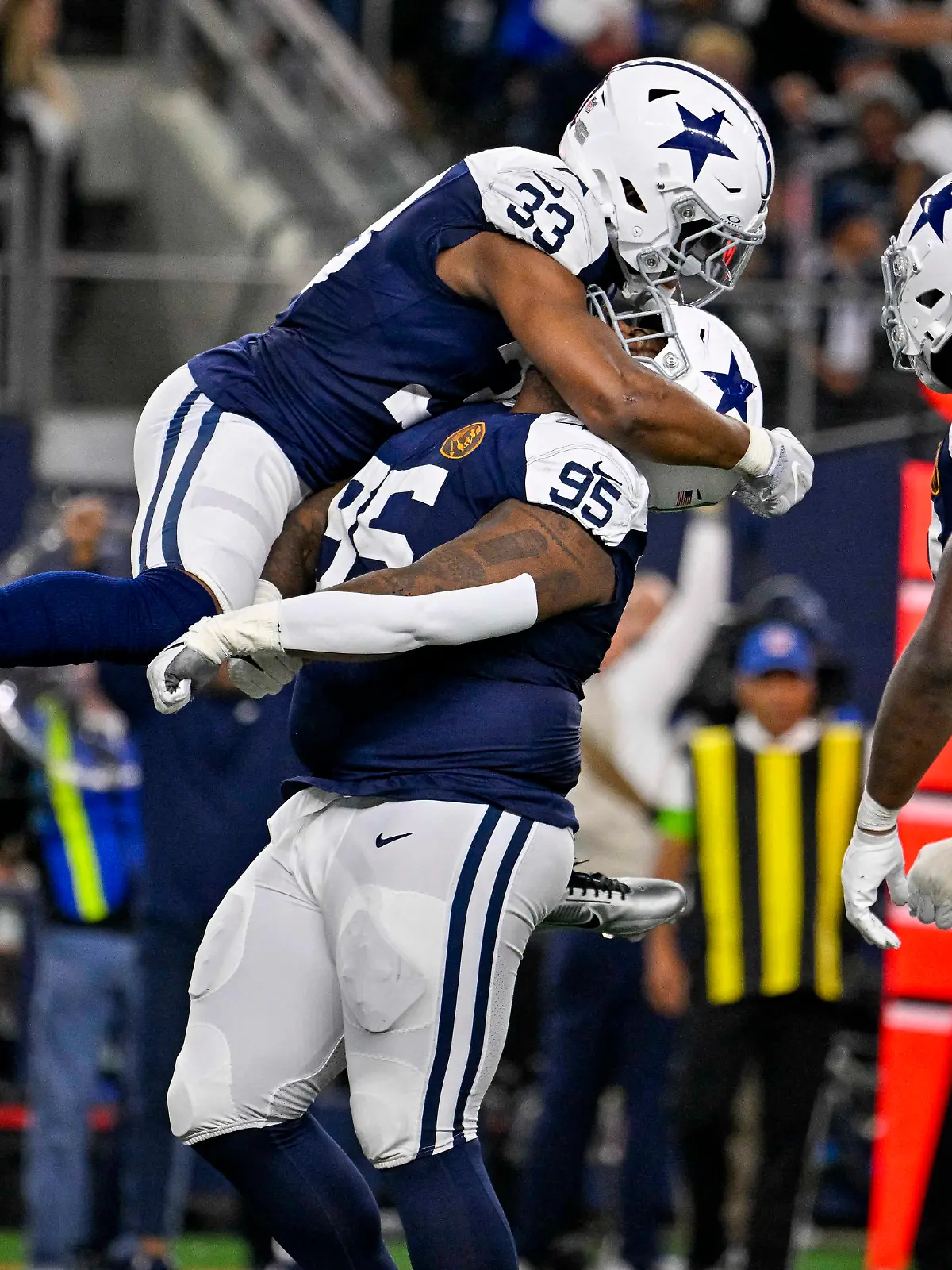 Nov 23, 2023; Arlington, Texas, USA; Dallas Cowboys linebacker Damone Clark (33) and defensive tackle Johnathan Hankins (95) celebrates after the Cowboys make a stop on the Washington Commanders on fourth down to turn the ball over on downs during the second half at AT&T Stadium. Mandatory Credit: Jerome Miron-USA TODAY Sports