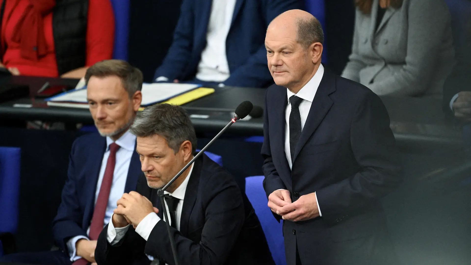 FILE PHOTO: Chancellor Olaf Scholz speaks next to Finance Minister Christian Lindner and Economy and Climate Minister Robert Habeck during a hearing at Germany’s lower house of parliament Bundestag following the ruling of Germany's Constitutional court that the government's re-location of 60 billion euros ($65 billion USD) of unused debt from the pandemic era to climate fund was illegal, in Berlin, Germany, November 15, 2023. REUTERS/Annegret Hilse/File Photo
