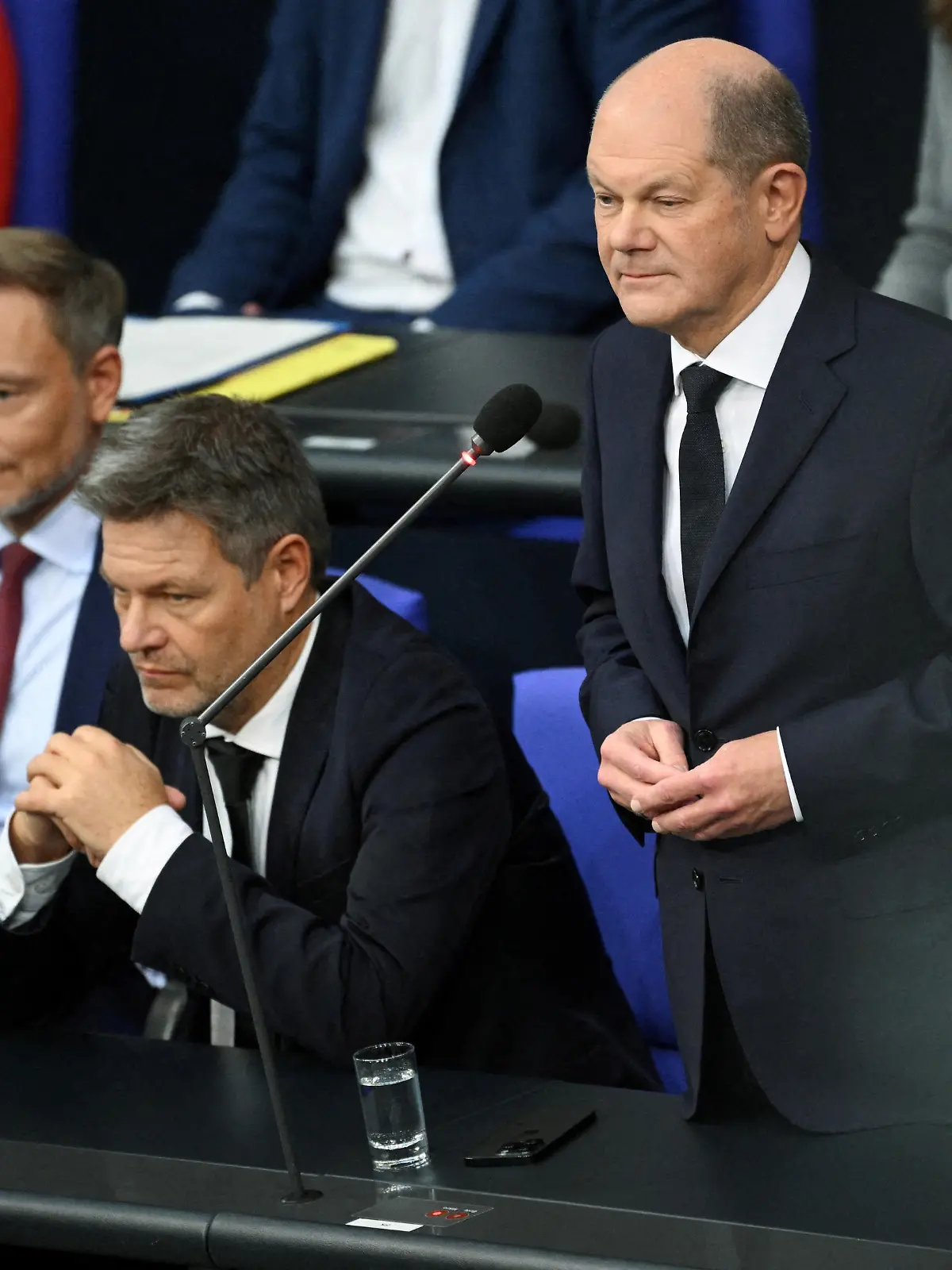 FILE PHOTO: Chancellor Olaf Scholz speaks next to Finance Minister Christian Lindner and Economy and Climate Minister Robert Habeck during a hearing at Germany’s lower house of parliament Bundestag following the ruling of Germany's Constitutional court that the government's re-location of 60 billion euros ($65 billion USD) of unused debt from the pandemic era to climate fund was illegal, in Berlin, Germany, November 15, 2023.   REUTERS/Annegret Hilse/File Photo