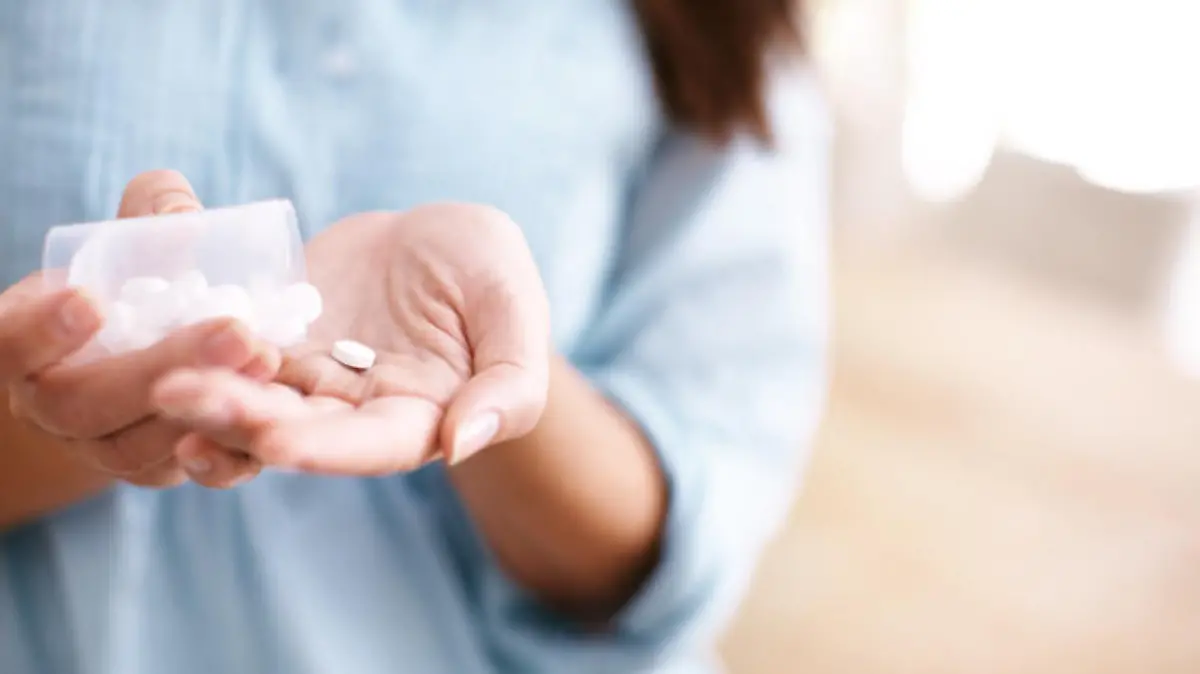 A mature woman taking medication