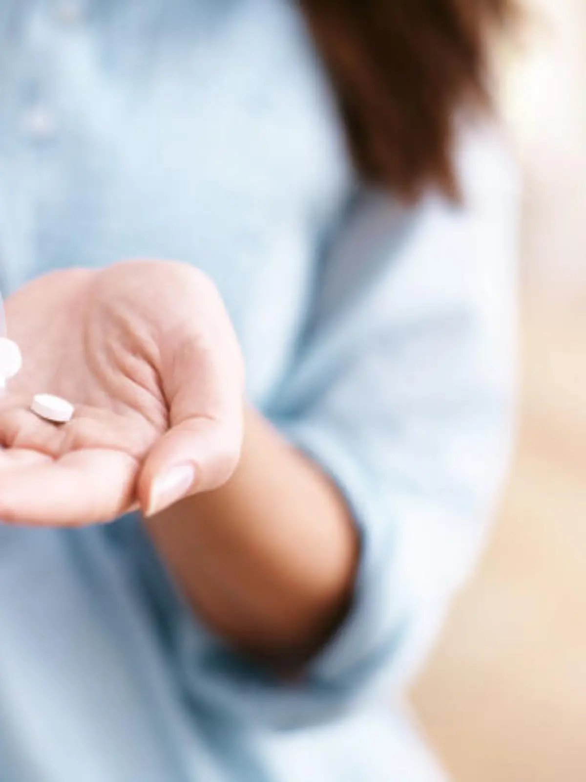 A mature woman taking medication