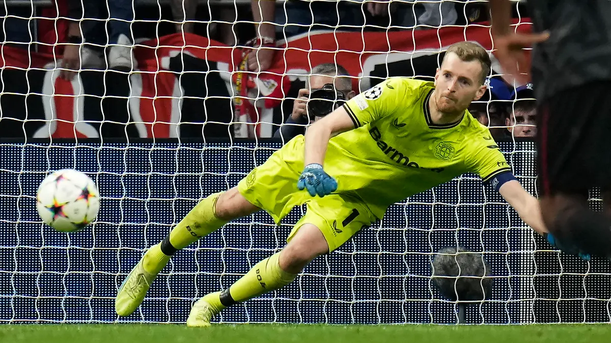 Leverkusen's goalkeeper Lukas Hradecky saves a penalty during the group B Champions League soccer match between Atletico Madrid and Bayer 04 Leverkusen at the Civitas Metropolitano stadium in Madrid, Spain, Wednesday, Oct. 26, 2022. (AP Photo/Manu Fernaandez)