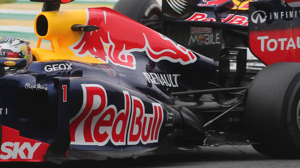 Red Bull driver Sebastian Vettel, of Germany, steers his car ahead of Ferrari driver Felipe Massa, of Brazil, during the Formula One Brazilian Grand Prix at the Interlagos race track in Sao Paulo, Brazil, Sunday, Nov. 25, 2012. Vettel overcame a first-lap crash to clinch his third straight Formula One championship title on Sunday, finishing sixth in an incident-filled Brazilian Grand Prix won by Jenson Button under pouring rain. (AP Photo/Andre Penner)