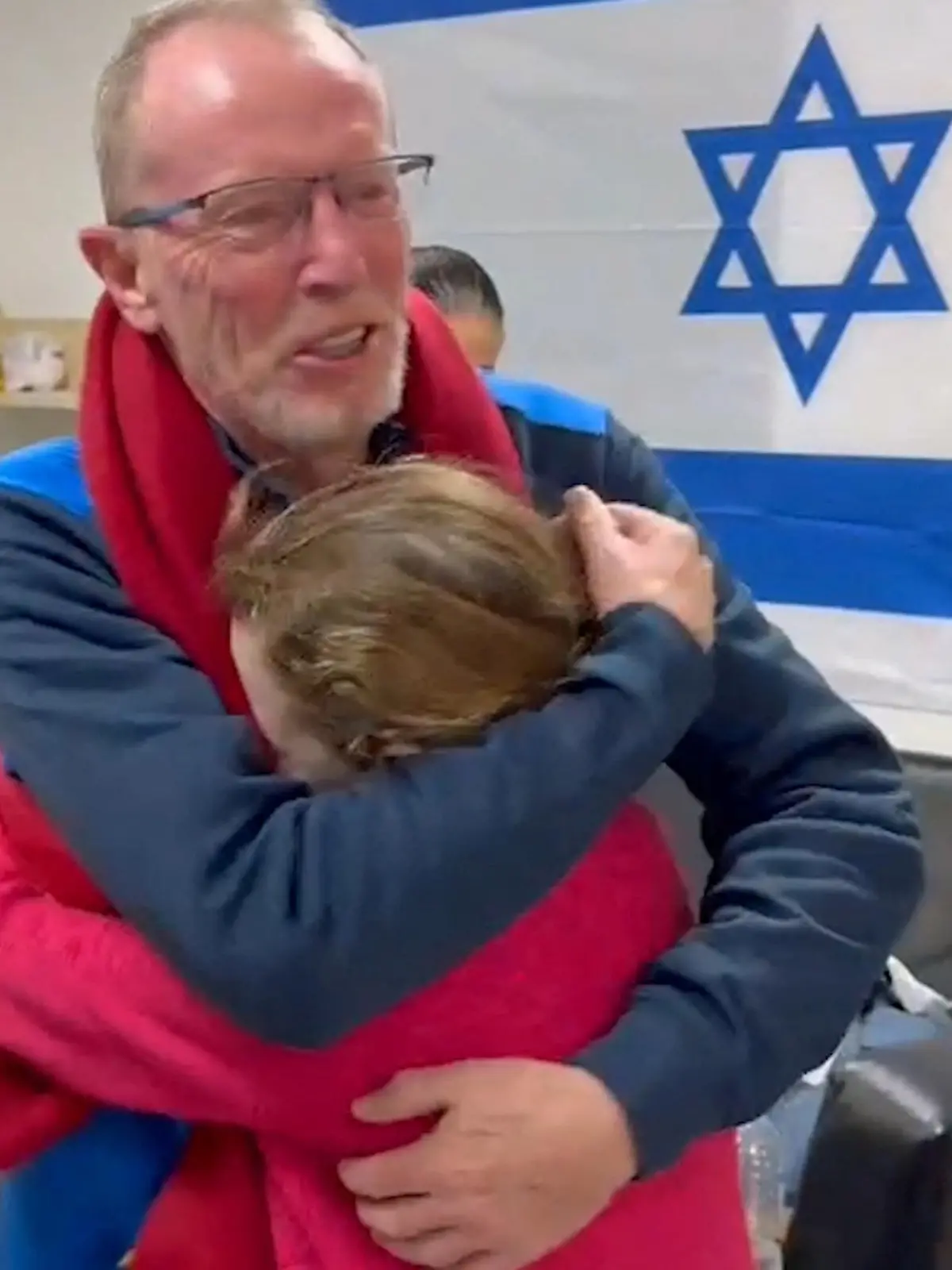 Irish-Israeli girl Emily Hand, who was abducted by Hamas gunmen during the October 7 attack on Israel, meets her father Thomas Hand after being released as part of a hostages-prisoners swap deal between Hamas and Israel amid a temporary truce, at an unknown location in Israel, in this screengrab from a handout video released November 26, 2023.   Israel Defense Forces/Handout via REUTERS THIS IMAGE HAS BEEN SUPPLIED BY A THIRD PARTY.