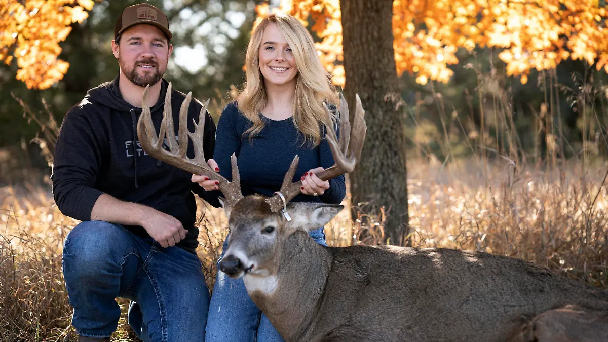 Cole Bures and Samantha Camenzind pose with the deer she shot near Filley, Neb., before he proposed to her on Nov. 12, 2023. Bures asked Camenzind to marry him during a photo shoot to commemorate the moment. (Brenton Lammers/Lammers Media via AP)