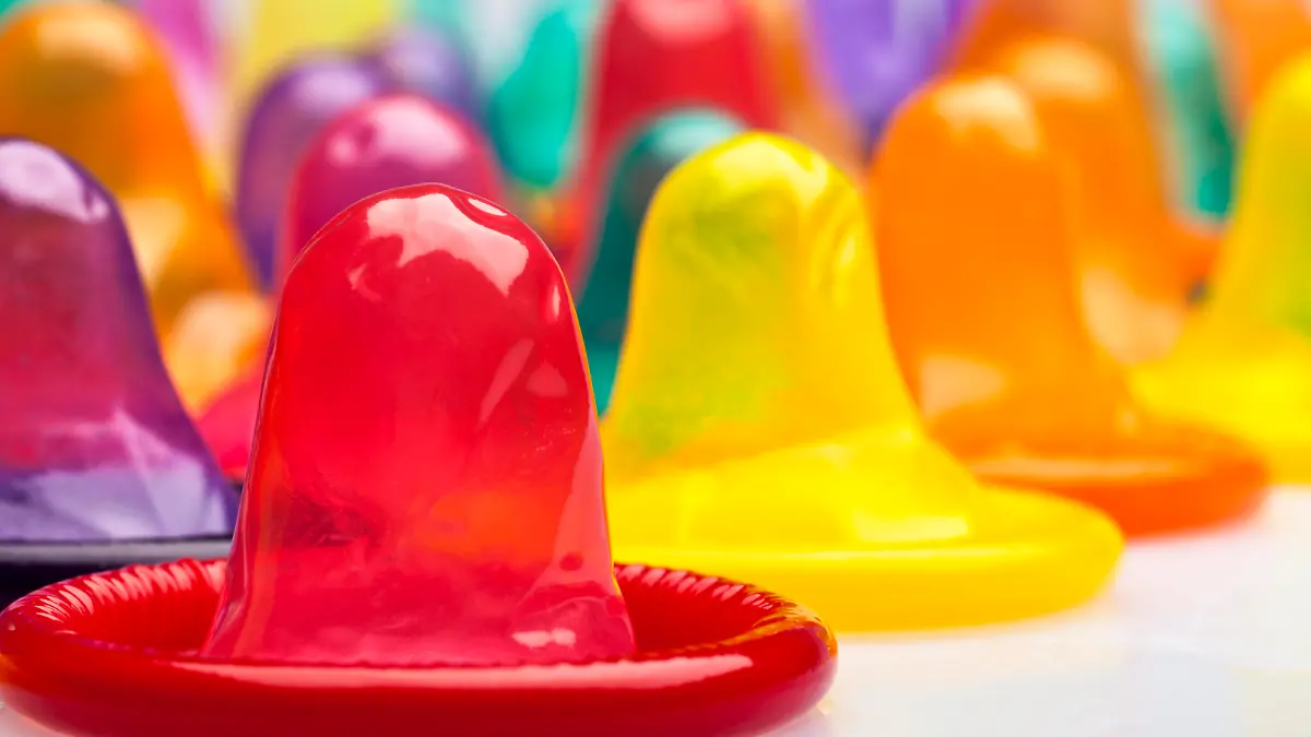 Extreme close-up of condoms in a rainbow of colors.