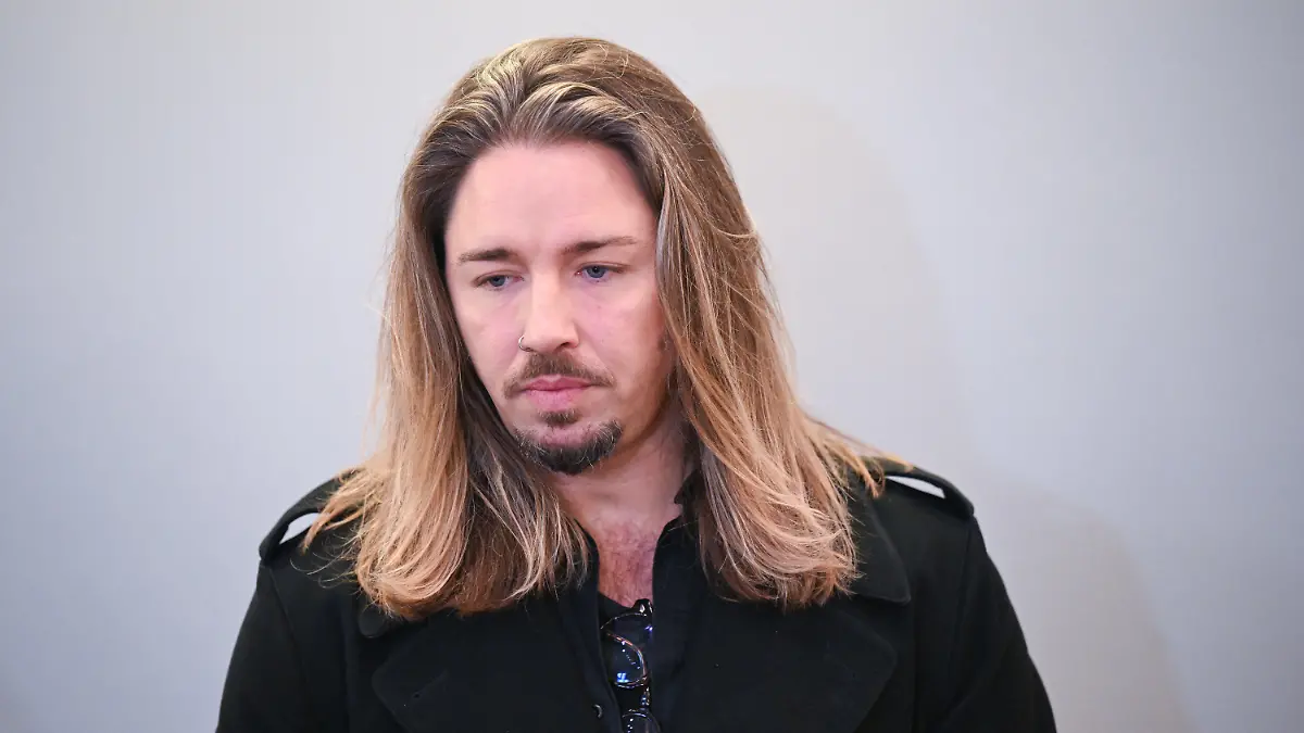dpatopbilder - 28.11.2023, Sachsen, Leipzig: Der deutsche Rockmusiker Gil Ofarim steht im Saal des Landgerichts in Leipzig. Hier läuft der Prozess gegen Ofarim wegen falscher Verdächtigung und Verleumdung. Der Musiker hatte im Oktober 2021 in einem Video Antisemitismus-Vorwürfe gegen ein Leipziger Hotel erhoben. Nach Einschätzung der Staatsanwaltschaft Leipzig hat sich der Vorfall aber nicht so zugetragen. Foto: Hendrik Schmidt/dpa +++ dpa-Bildfunk +++