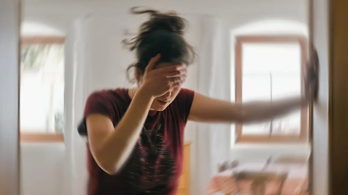Woman suffering from vertigo or dizziness or other health problem of brain or inner ear.