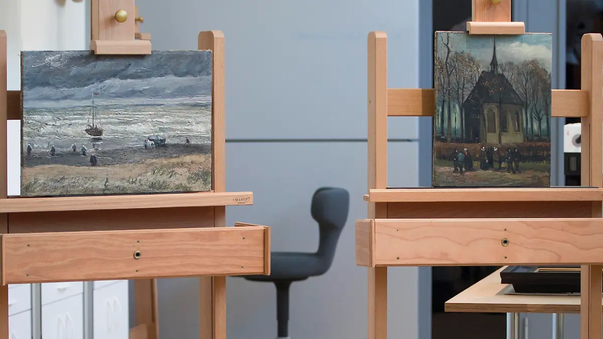 Museum director Axel Ruger, right, talks during a presentation of two restored paintings by Dutch master Vincent van Gogh, View of the Sea at Scheveningen (1882), left, and Congeregation Leaving the Reformed Church in Nuenen (1884-1885), at the Van Gogh Museum in Amsterdam, Netherlands, Tuesday, April 16, 2019. The two painting were were stolen an went missing for 14 years before being recovered in Italy in 2016. (AP Photo/Peter Dejong)