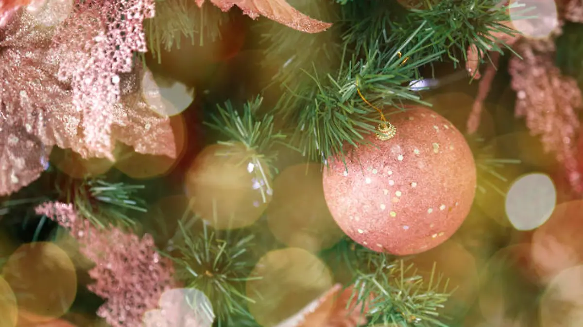 scene background in christmas tree and festive details. Christmas arrangement in pink tones