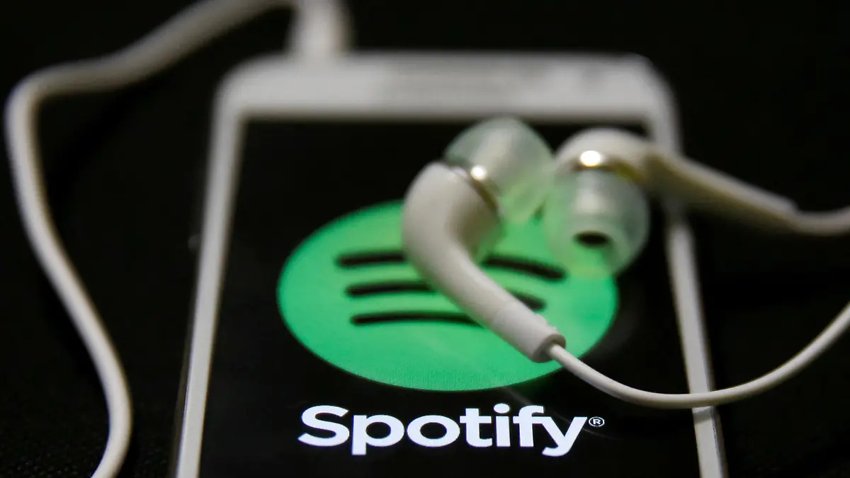 FILE PHOTO: Earphones are seen on top of a smart phone with a Spotify logo on it, in Zenica February 20, 2014. REUTERS/Dado Ruvic/File Photo