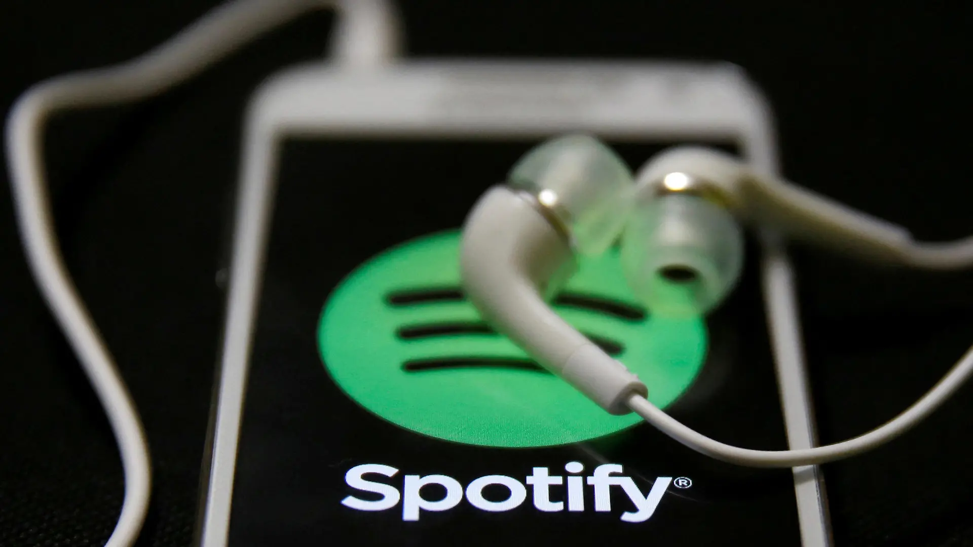 FILE PHOTO: Earphones are seen on top of a smart phone with a Spotify logo on it, in Zenica February 20, 2014. REUTERS/Dado Ruvic/File Photo