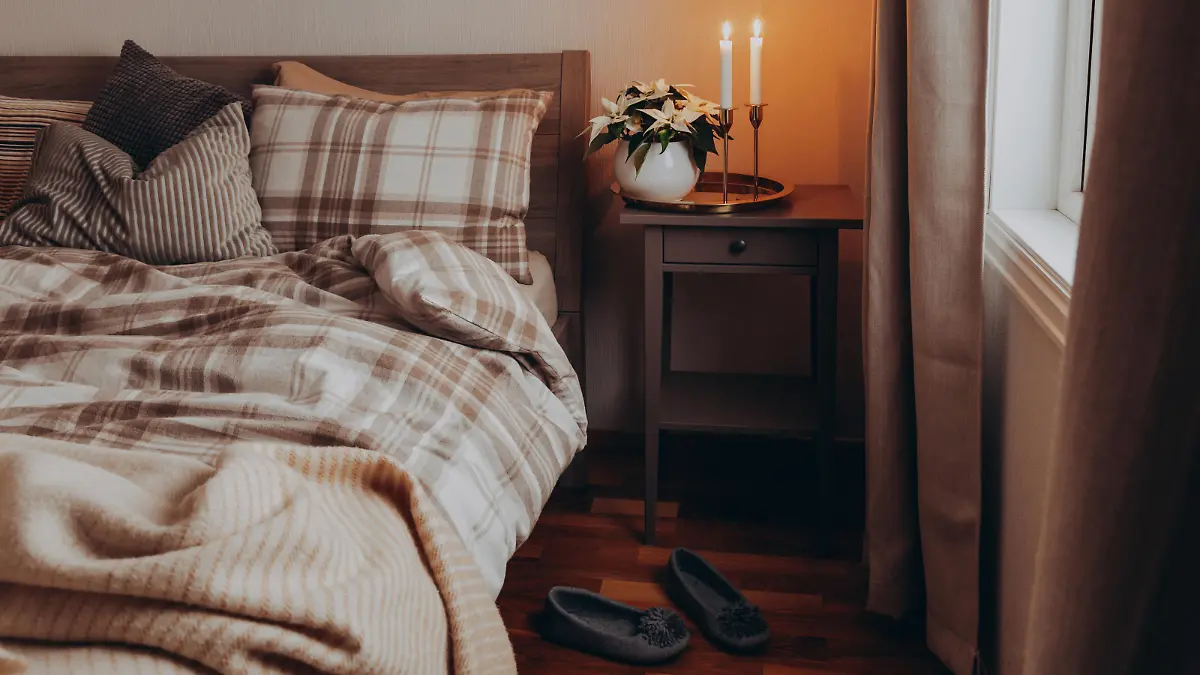cozy scandinavian bedroom interior in natural tones, blanket candles houseplants