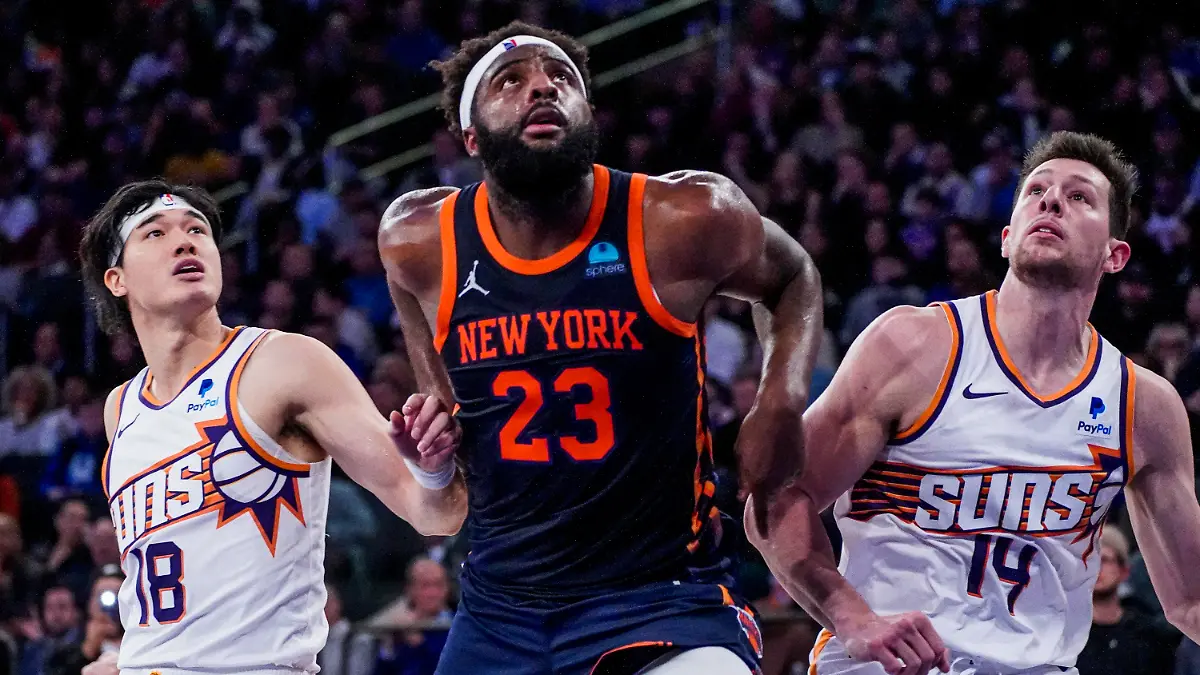 New York Knicks center Mitchell Robinson (23) fights for rebounding position against Phoenix Suns forwards Yuta Watanabe (18) and Drew Eubanks (14) during the second half of an NBA basketball game in New York, Sunday, Nov. 26, 2023. (AP Photo/Peter K. Afriyie)