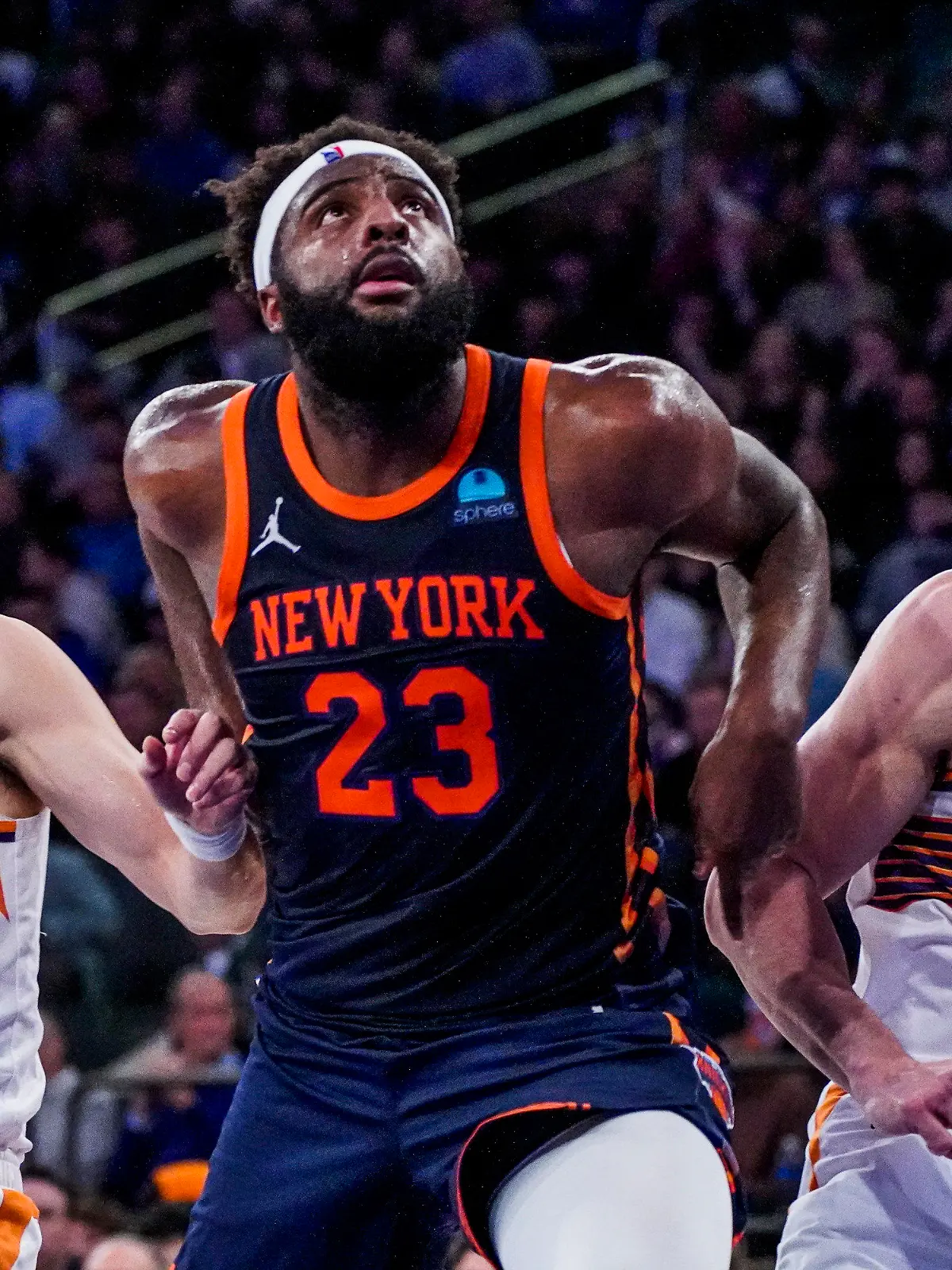 New York Knicks center Mitchell Robinson (23) fights for rebounding position against Phoenix Suns forwards Yuta Watanabe (18) and Drew Eubanks (14) during the second half of an NBA basketball game in New York, Sunday, Nov. 26, 2023. (AP Photo/Peter K. Afriyie)