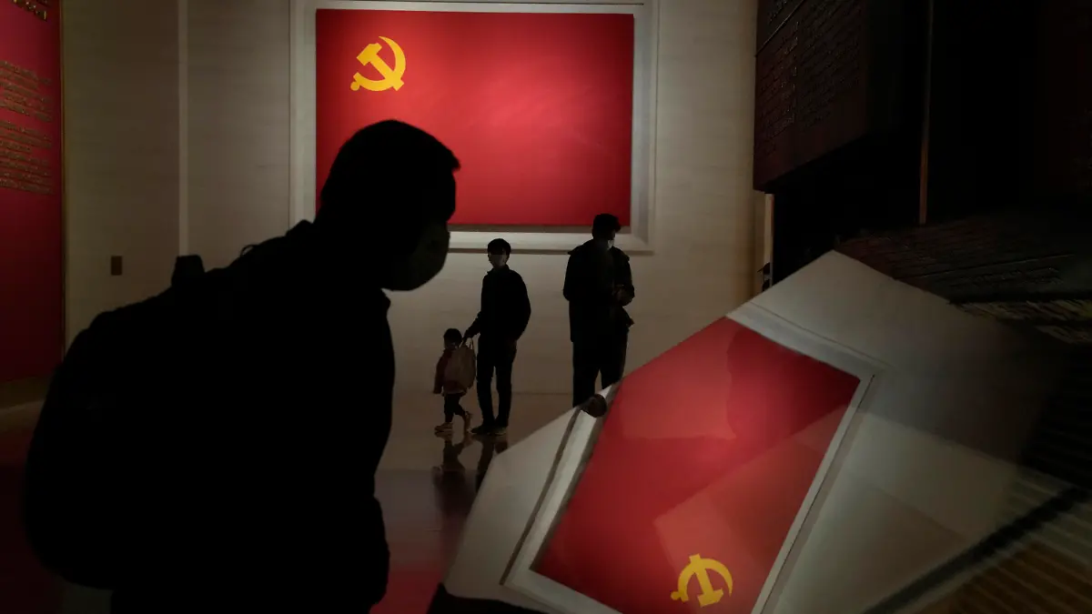 Visitors pass by the Communists party flags at the Museum of the Community Party of China in Beijing, Wednesday, Oct. 12, 2022. A meeting of the ruling Communist Party to install leaders gives President Xi Jinping, China's most influential figure in decades, a chance to stack the ranks with allies who share his vision of intensifying pervasive control over entrepreneurs and technology development. (AP Photo/Ng Han Guan)