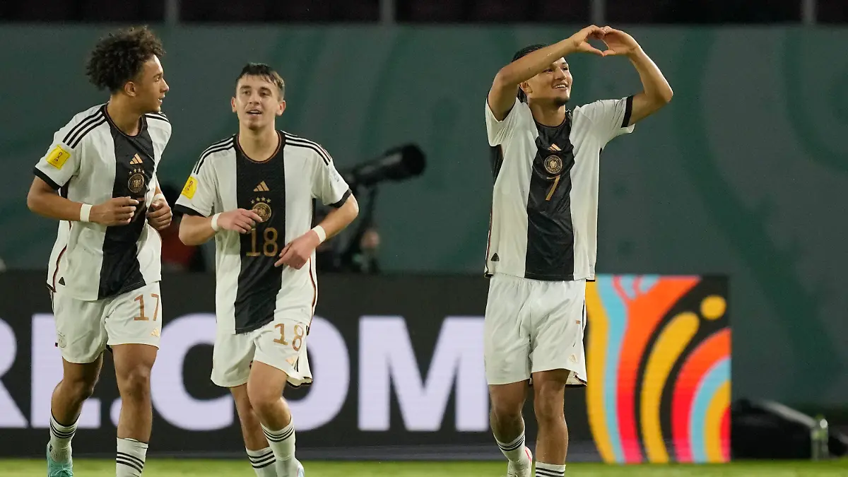 Germany's Paris Brunner, right, celebrates with teammates after scoring his team's opening goal through a penalty kick during their U-17 World Cup final soccer match against France at Manahan Stadium in Surakarta, Indonesia, Saturday, Dec. 2, 2023. (AP Photo/Achmad Ibrahim)