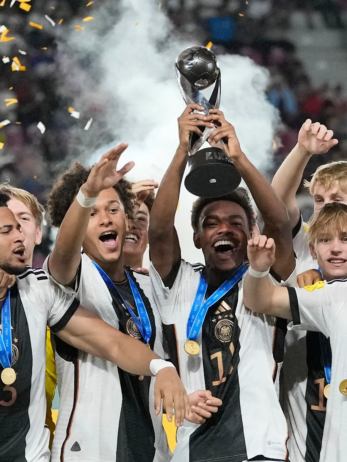 Team Germany celebrates on the podium with their trophy after their victory over France in the U-17 World Cup final soccer match at Manahan Stadium in Surakarta, Indonesia, Saturday, Dec. 2, 2023. (AP Photo/Achmad Ibrahim)