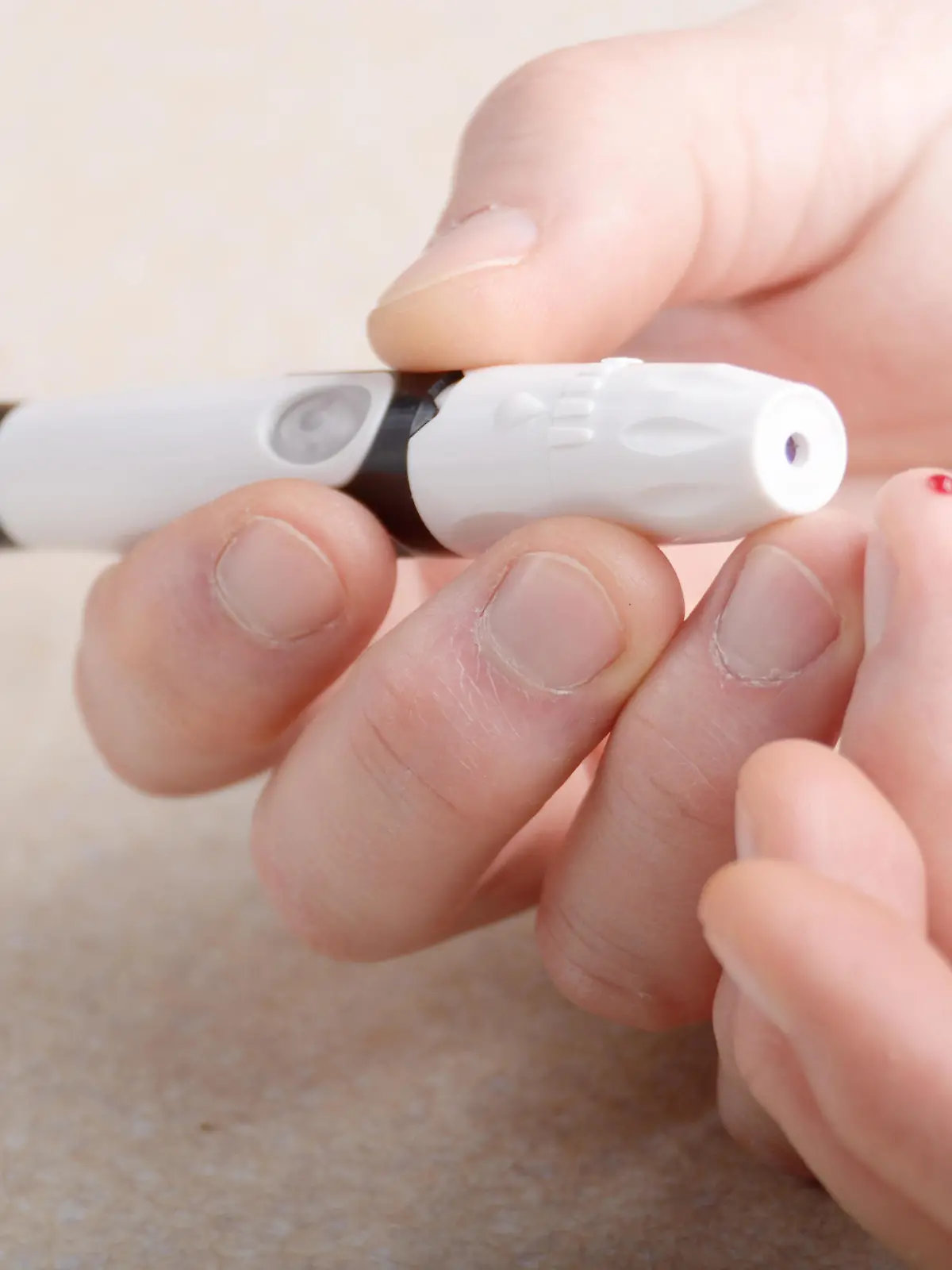 Man Pierce his fingertip before doing blood test with personal glucometer