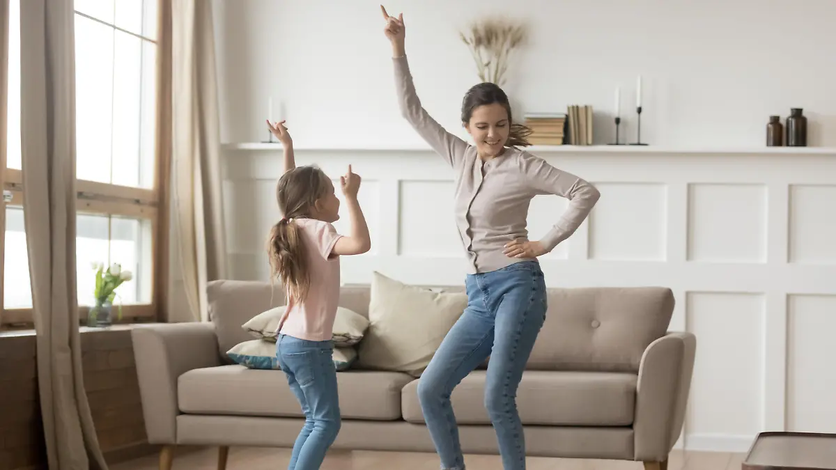 Active family young mother dance having fun with little preschool or school age daughter older younger sister listens happy song moving together, leisure activities with kid positive emotions concept