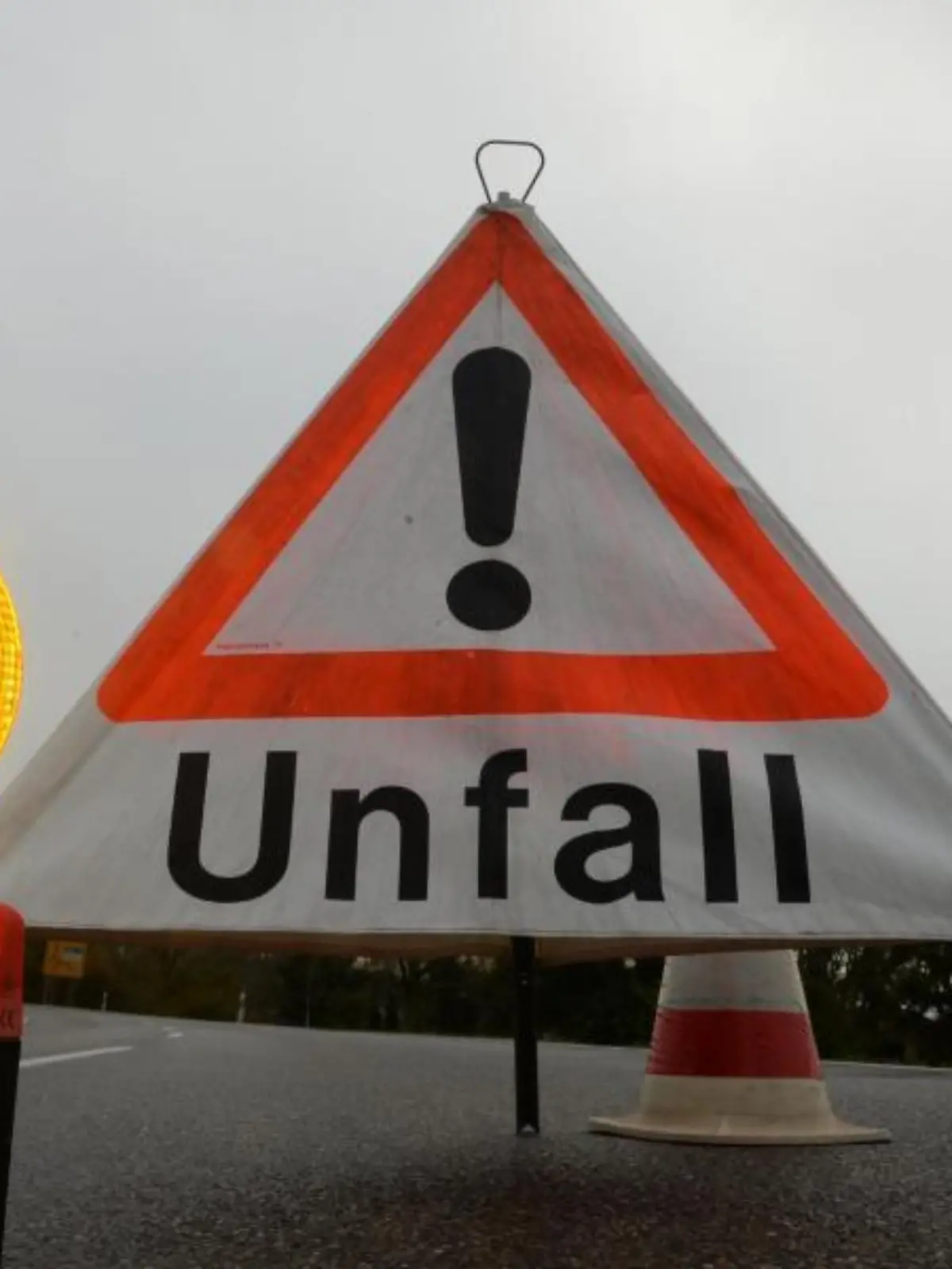Ein Warndreieck mit der Aufschrift «Unfall» steht auf der Straße