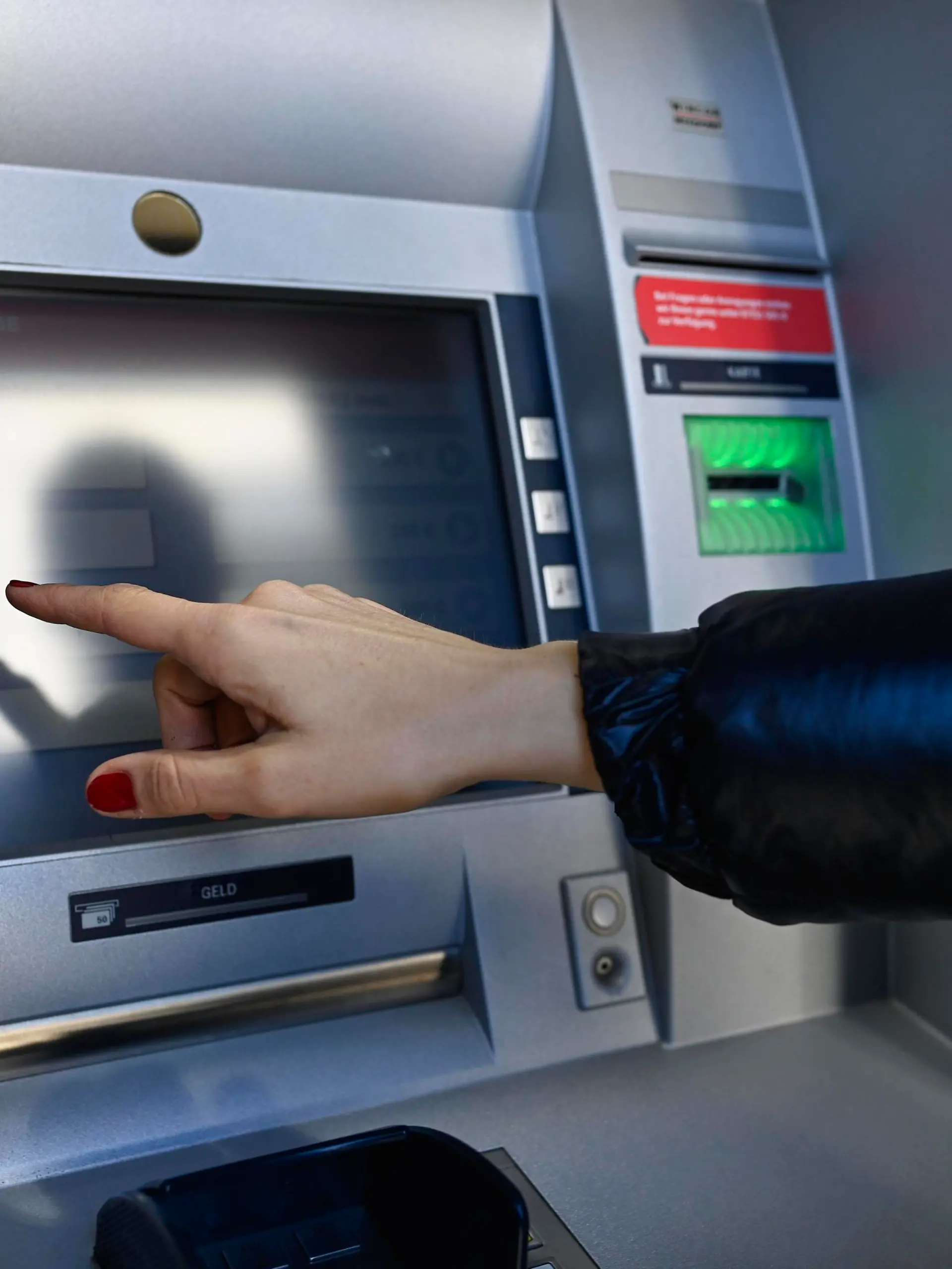 Frau tippt am Touchscreen eines Geldautomaten einer Sparkasse, Waiblingen, Baden-Württemberg, Deutschland, Europa || Modellfreigabe vorhanden