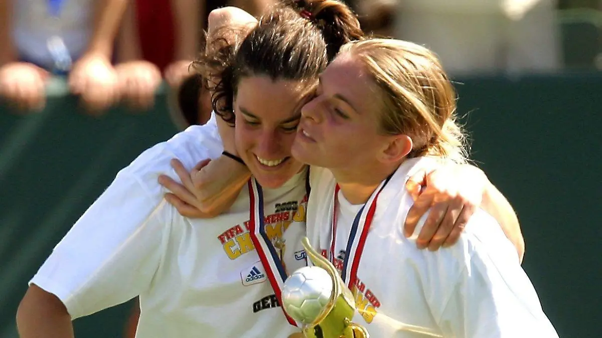 ARCHIV - 12.10.2003, USA, Carson: Die Deutschen Birgit Prinz (l) und Nia Künzer, die den Weltmeisterschafts-Pokal in den Händen hält, umarmen sich auf der Ehrenrunde. Künzer wird beim Deutschen Fußball-Bund Direktorin für den Frauenfußball. Die 43 Jahre alte Weltmeisterin von 2003 tritt das neu geschaffene Amt am 1. Januar an, teilte der DFB am Donnerstag mit. Foto: picture alliance / dpa +++ dpa-Bildfunk +++
