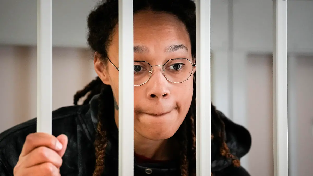 FILE - WNBA star and two-time Olympic gold medalist Brittney Griner speaks to her lawyers standing in a cage at a court room prior to a hearing, in Khimki just outside Moscow, Russia, Tuesday, July 26, 2022. A Russian court has on Tuesday, Oct. 23 started hearing American basketball star Brittney Griner's appeal against her nine-year prison sentence for drug possession. (AP Photo/Alexander Zemlianichenko, Pool, File)