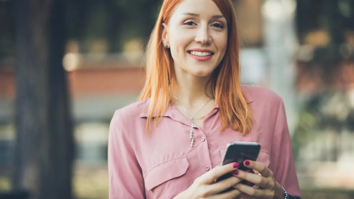 It's easier with the technology. Business woman using phone on street. Close up