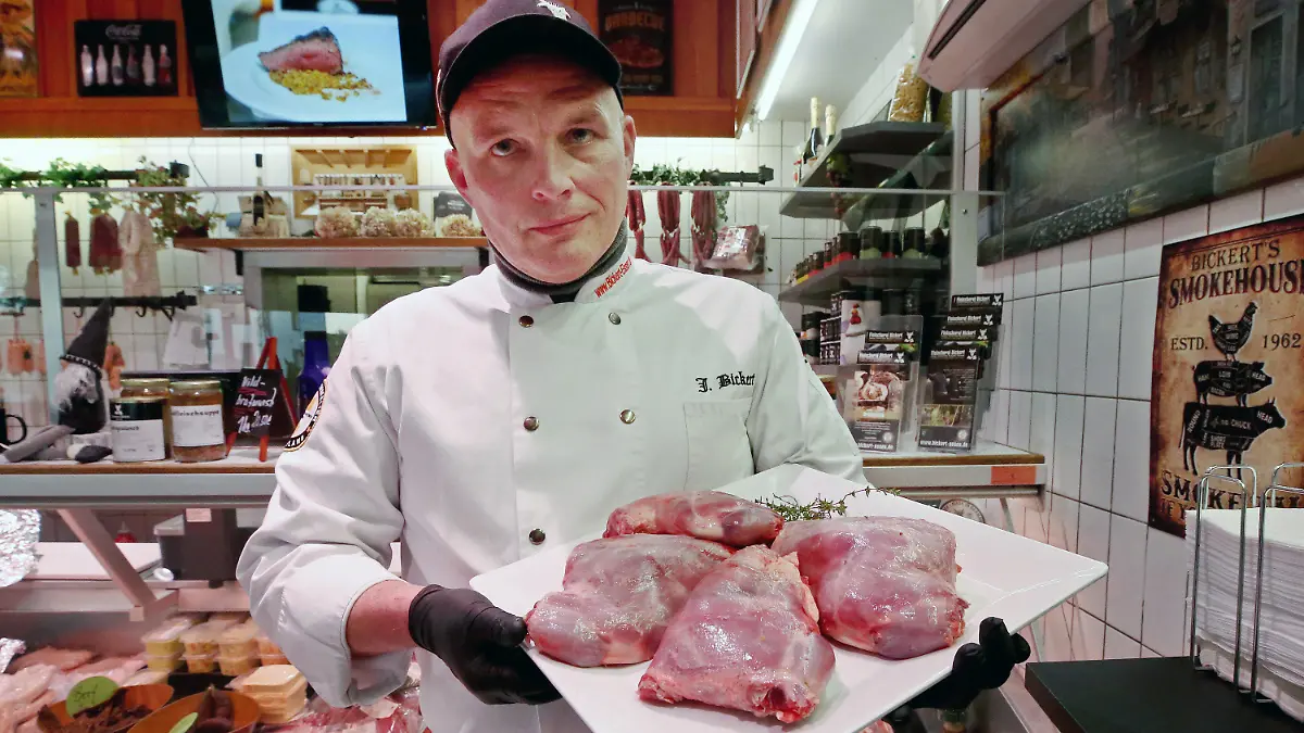 PRODUKTION - 08.12.2023, Nordrhein-Westfalen, Essen: Jürgen Bickert, Metzgermeister und geprüfter "Fleischsommelier", präsentiert in seiner Metzgerei Nutria-Keulen. Nutrias gelten als invasive Art und werden mit Fallen bejagt. Jürgen Bickert empfiehlt die geschmorten Keulen als Weihnachtsbraten.       (zu dpa "Metzger empfiehlt Nutria-Keule zu Weihnachten - «herrliches Fleisch»") Foto: Roland Weihrauch/dpa +++ dpa-Bildfunk +++