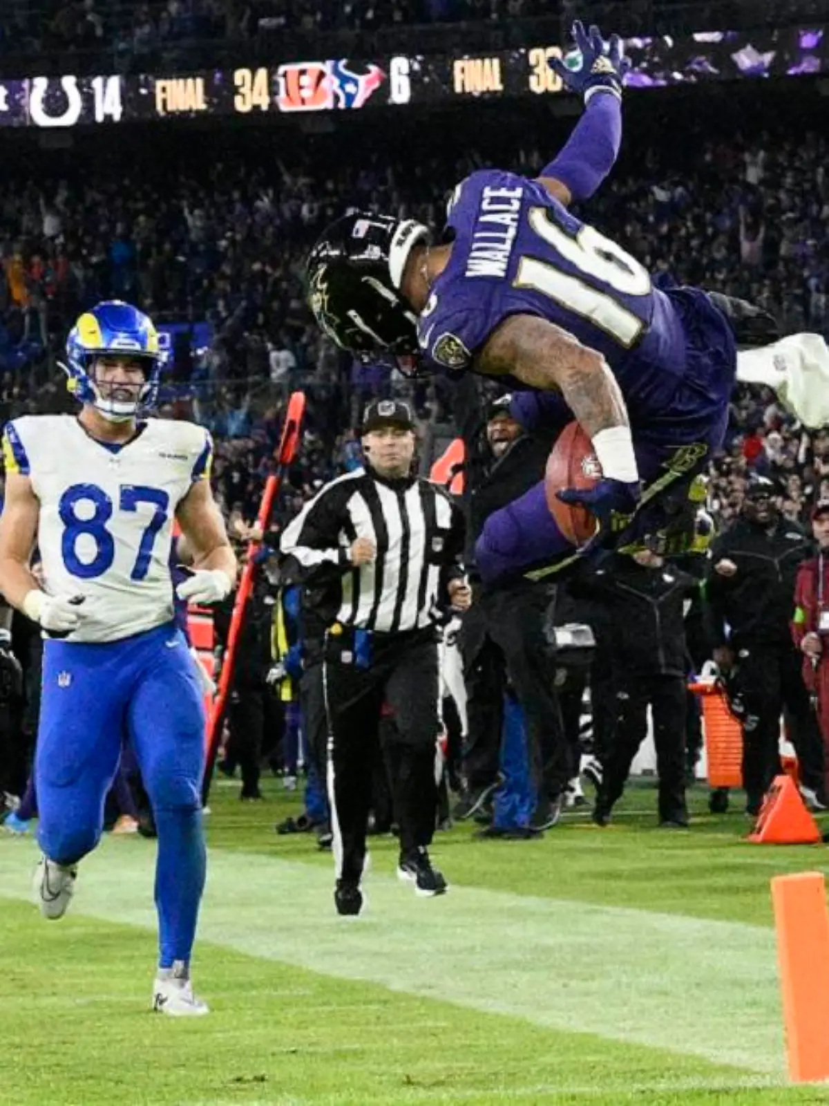 Baltimore Ravens punt returner Tylan Wallace (16) starts to celebrate as he returns a punt for a game-winning touchdown as Los Angeles Rams tight end Davis Allen (87) and Ravens linebacker Del'Shawn Phillips (53) look on during overtime of an NFL football game Sunday, Dec. 10, 2023, in Baltimore. The Ravens won 37-31. (AP Photo/Nick Wass)