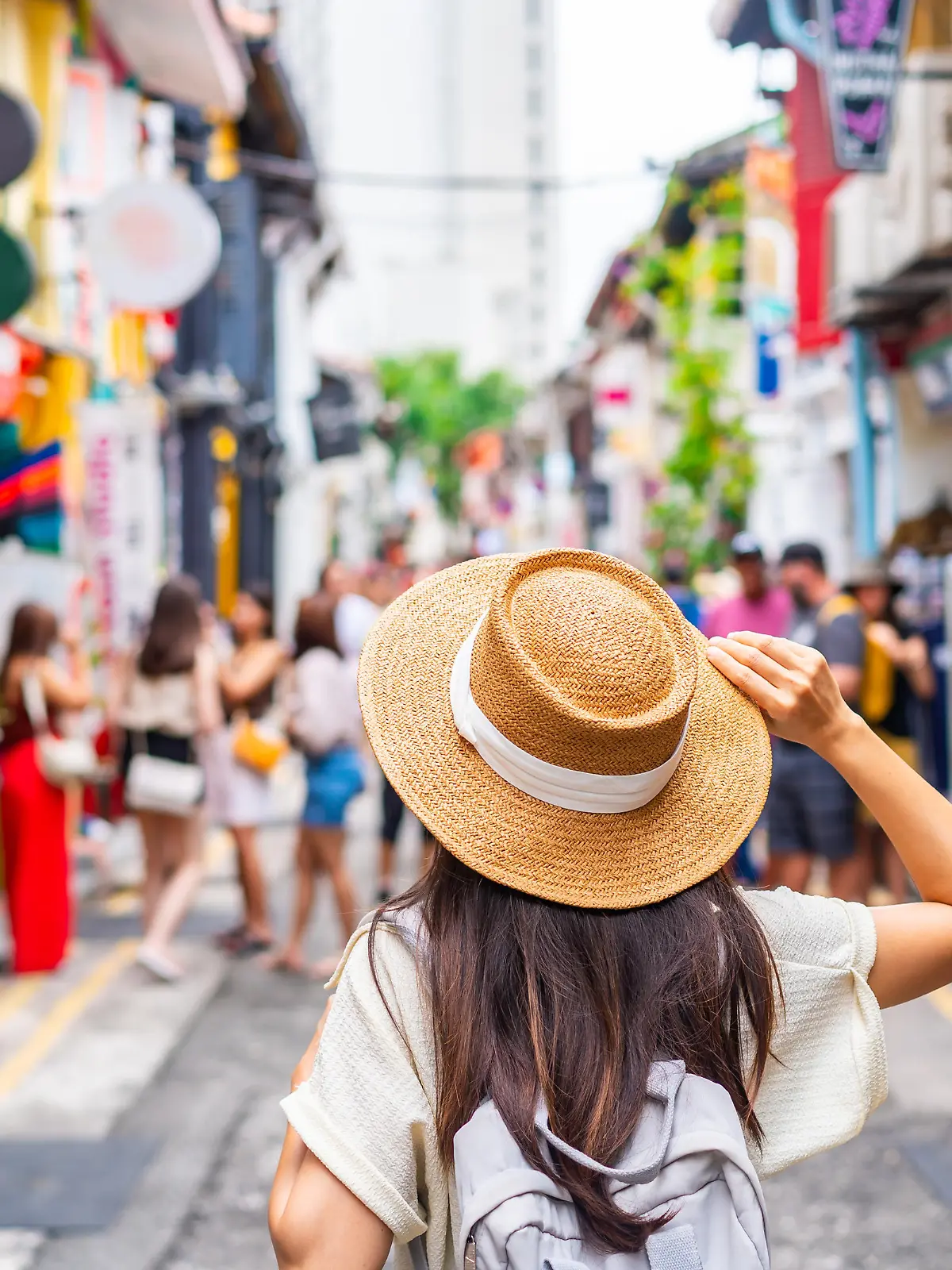 Young woman tourist with backpack walking at Haji Lane in Singapore