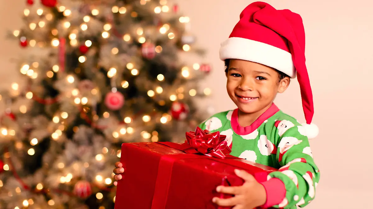 A young boy is excited for Christmas morning and the opening of presents.