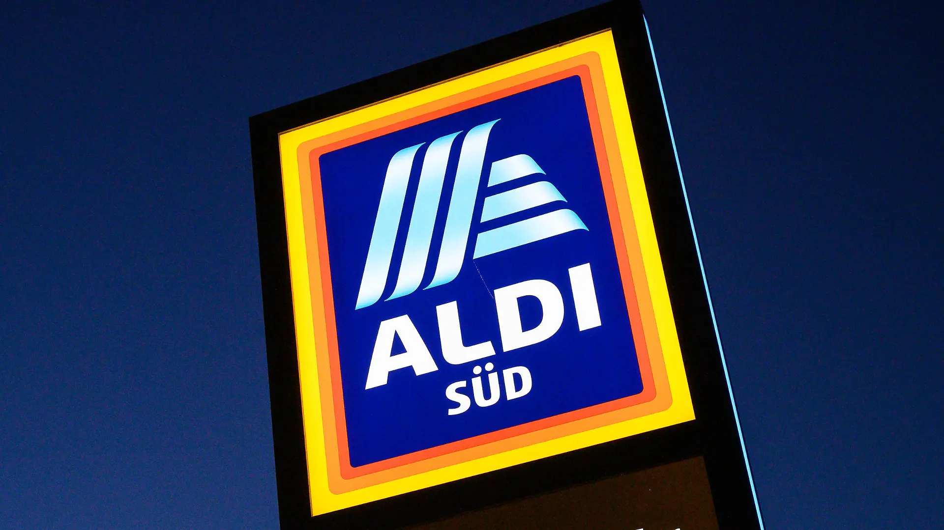 ARCHIV - 06.12.2019, Baden-Württemberg, Aichtal: Ein Schild des Discounters Aldi Süd leuchtet. Der Discounter Aldi Süd will seinen Lebensmittel-Lieferdienst, der zuletzt in drei Städten getestet worden ist, vorerst nicht auf sein ganzes Verbreitungsgebiet ausweiten. (zu dpa: «Aldi Süd will Lieferdienst nach Test vorerst nicht ausbauen») Foto: Sebastian Gollnow/dpa +++ dpa-Bildfunk +++