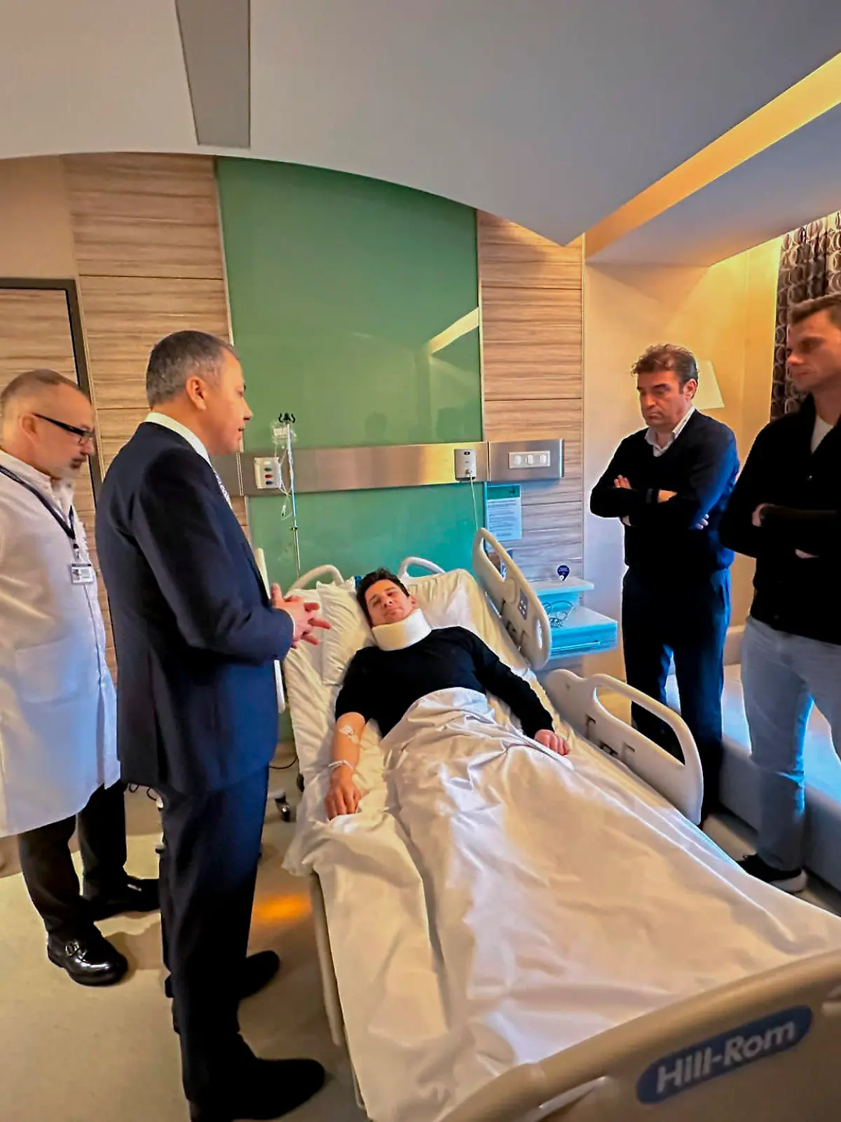 In this handout photo released by Turkish Interior Ministry, Turkish referee Halil Umut Meler, center, rests in a bed as he talks to Turkish Interior Minister Ali Yerlikaya, third left, at Acibadem hospital in Ankara, Tuesday, Dec. 12, 2023. The Turkish Football Federation has suspended all league games in the country after a club president punched the referee in the face at the end of a top-flight match. (Turkish Interior Ministry via AP)