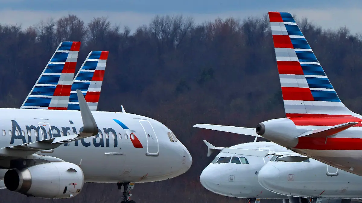 FILE - American Airlines planes sit stored at Pittsburgh International Airport on March 31, 2020, in Imperial, Pa. There will be no strike by American Airlines flight attendants around the Christmas and New Year's holidays. The National Mediation Board instead directed the airline and the Association of Professional Flight Attendants to keep negotiating over a new contract. (AP Photo/Gene J. Puskar, File)