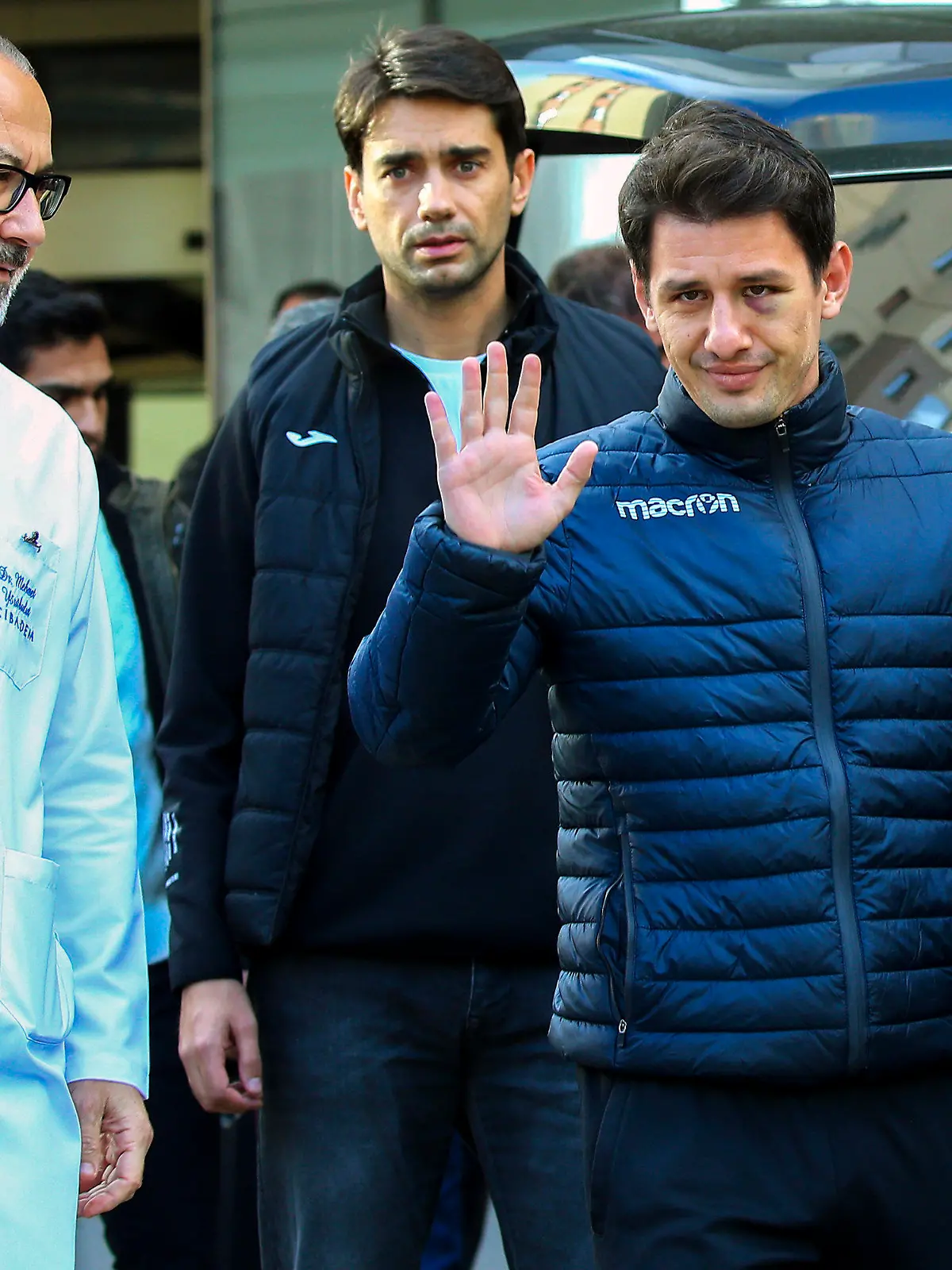 Turkish soccer referee Halil Umut Meler, right, gestures as he leaves Acibadem hospital in Ankara, Wednesday, Dec. 13, 2023. The Turkish Football Federation has suspended all league games after the president of a first-division soccer club punched a referee in the face at the end of a top-flight match. (AP Photo/Ali Unal)