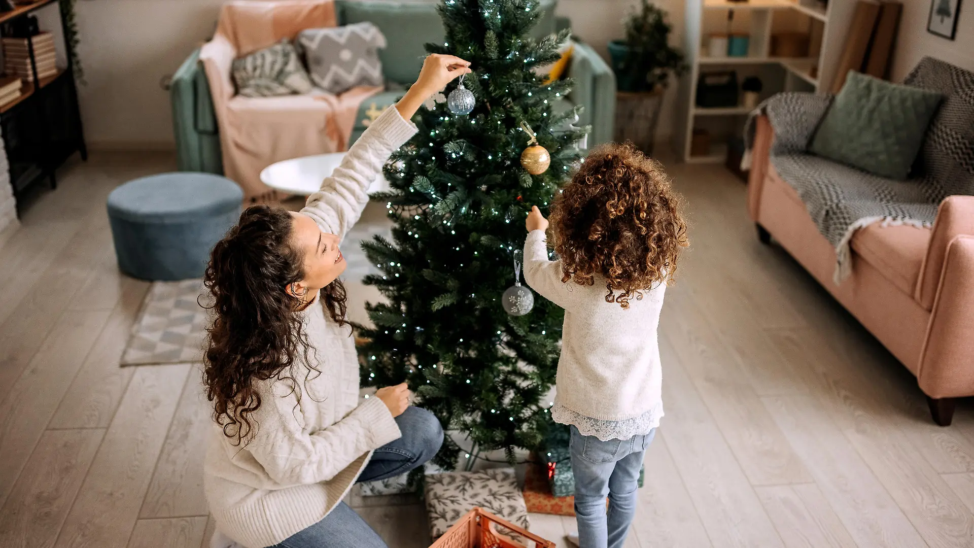 Mother and daughter decorating christmas tree