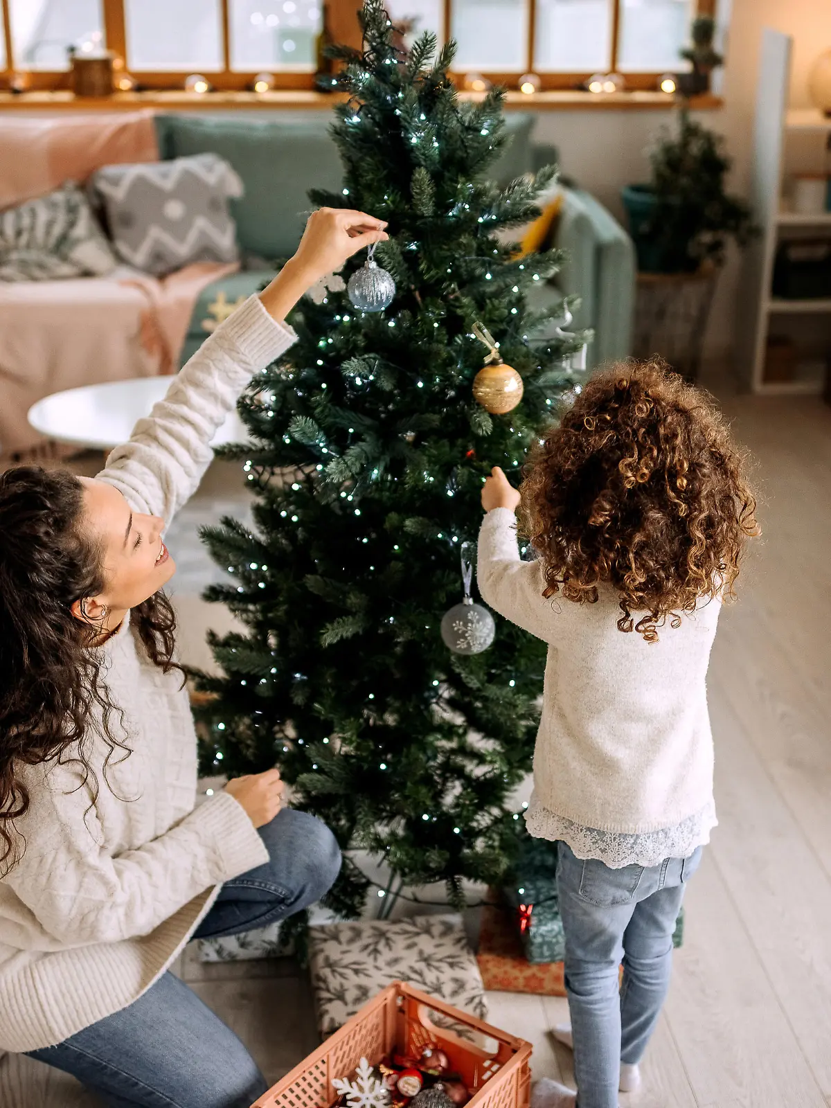Mother and daughter decorating christmas tree