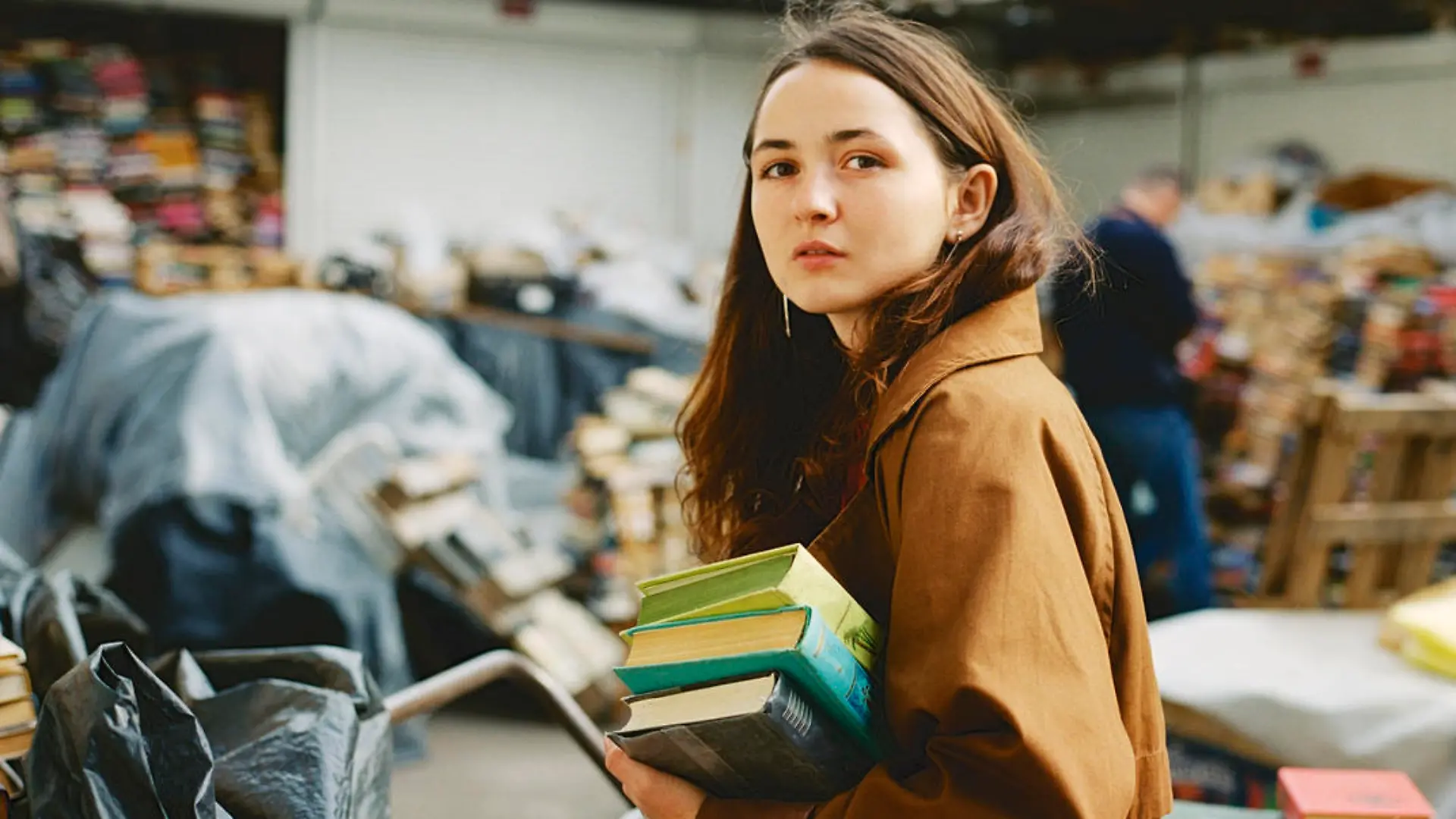 Young Caucasian buying books on vintage  book market