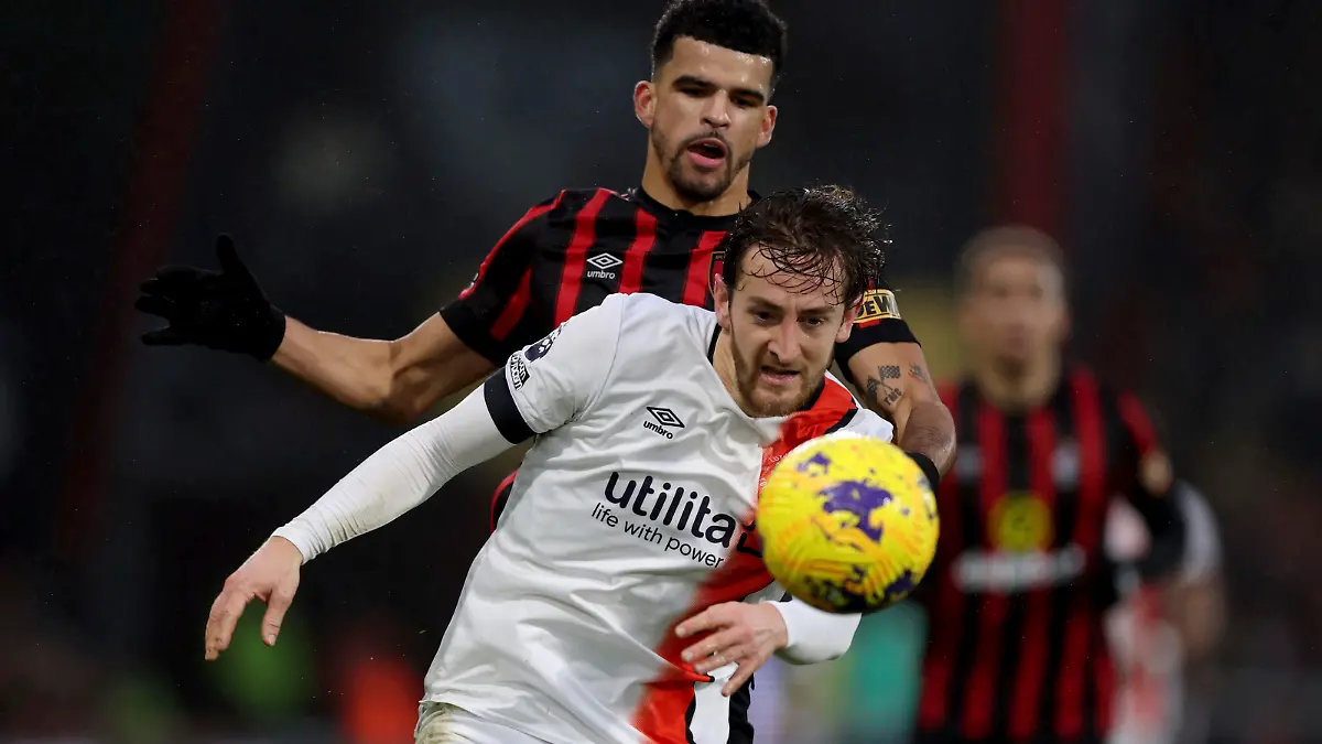 Luton Town's Tom Lockyer, front, and Bournemouth's Dominic Solanke battle for the ball during the English Premier League soccer match between Bournemouth and Luton Town at the Vitality Stadium, Bournemouth, England, Saturday Dec. 16, 2023. (Steven Paston/PA via AP)