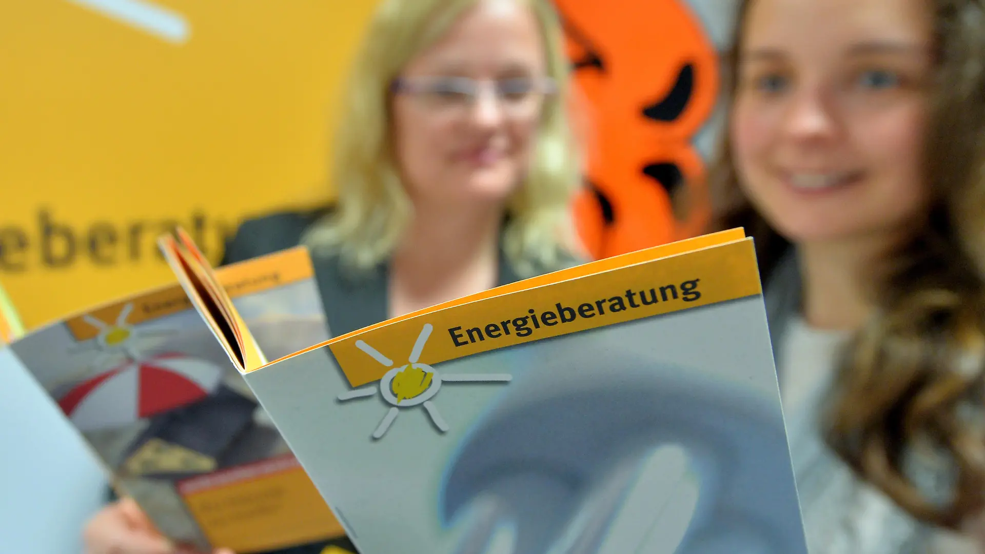 Zwei Mitarbeiterinnen der Verbraucherzentrale Sachsen blättern am 20.05.2014 in Leipzig in einer Broschüre zur Energieberatung. Die Einrichtung legt am selben Tag ihre Zahlen für 2013 vor und blickt auf das Jahr 2014 voraus. Foto: Hendrik Schmidt/dpa ++