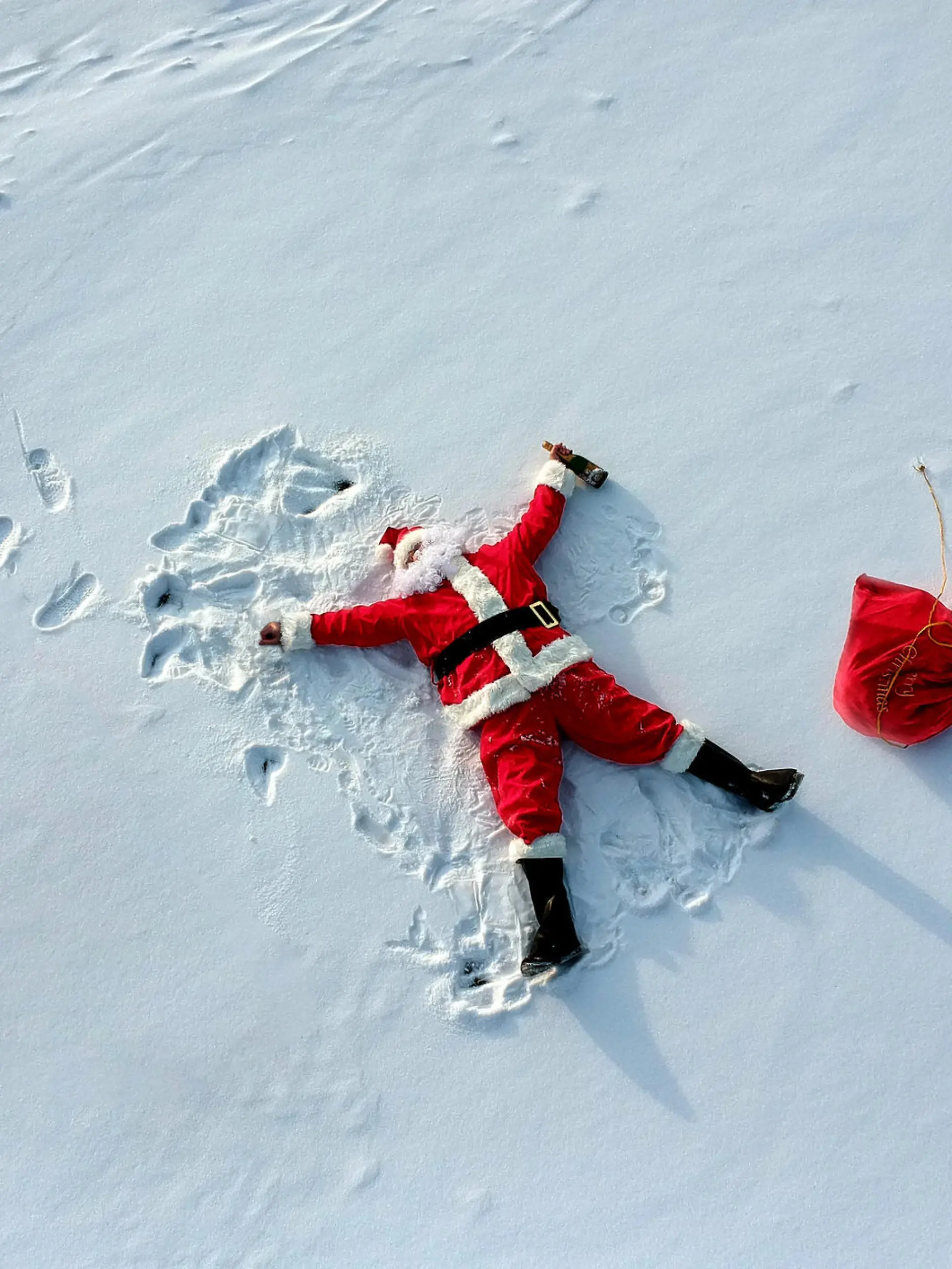 Drunk santa claus lying on the snow drone shot