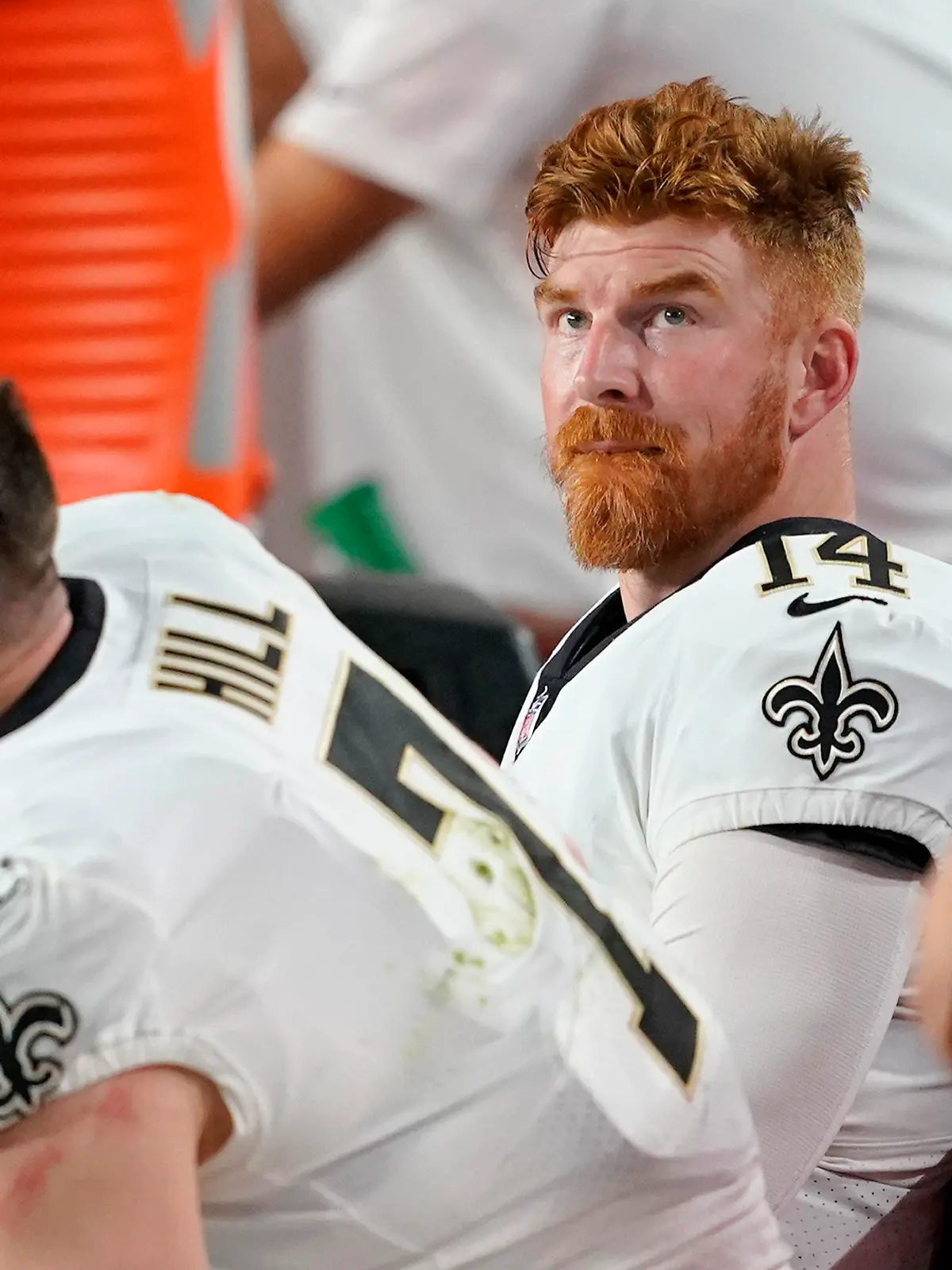 New Orleans Saints quarterback Andy Dalton (14) watches from the sideline next to Taysom Hill (7) during the second half of an NFL football game against the Arizona Cardinals, Thursday, Oct. 20, 2022, in Glendale, Ariz. (AP Photo/Matt York)