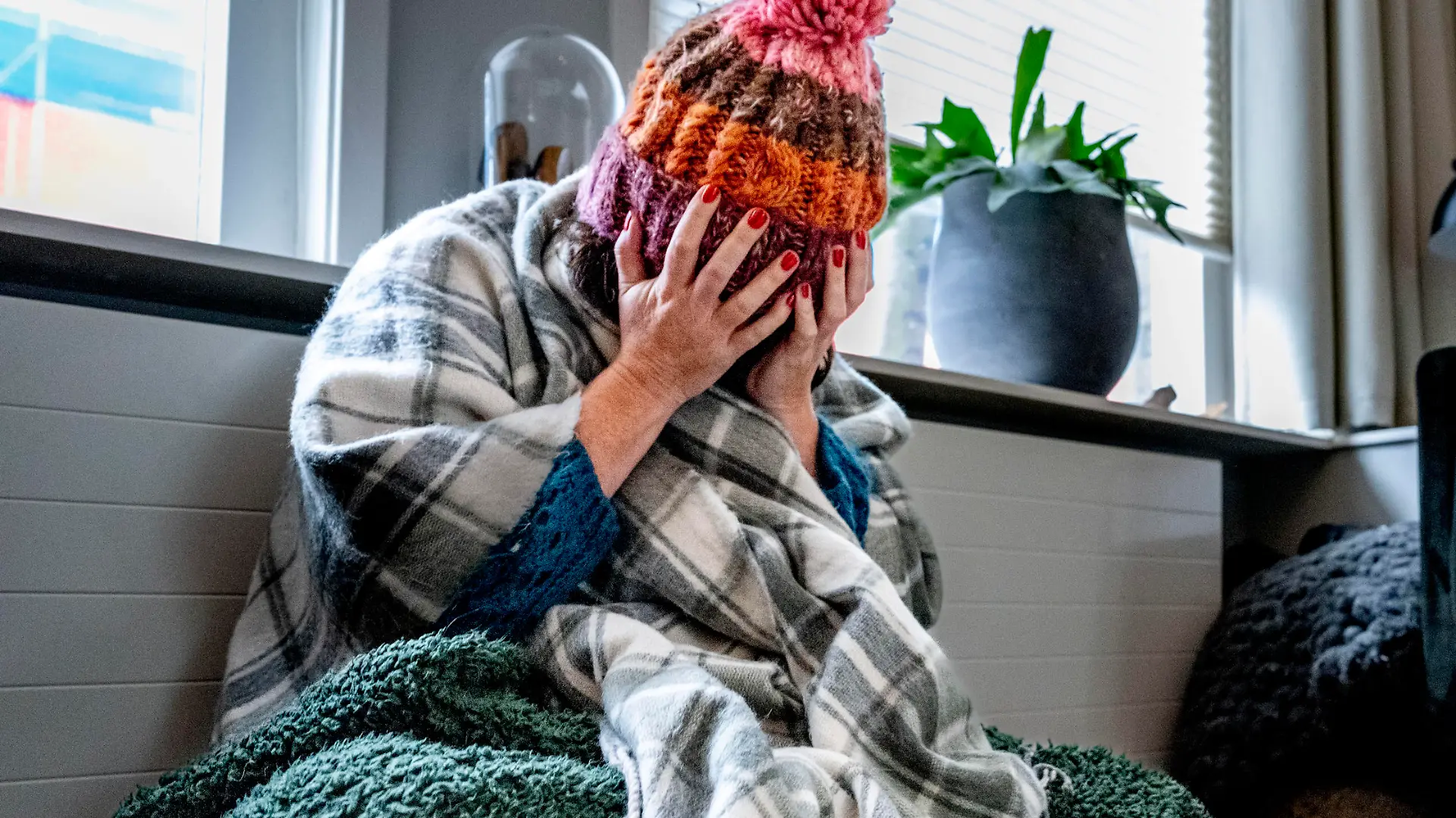 ILLUSTRATIVE - A woman is sitting with a blanket in her home because of the high gas and energy prices, they have to start shutting down. Now that inflation is unprecedentedly high and more and more families and companies are in danger of getting into trouble due to the high energy prices, the government is proposing a temporary price ceiling for gas and electricity. Robin Utrecht

